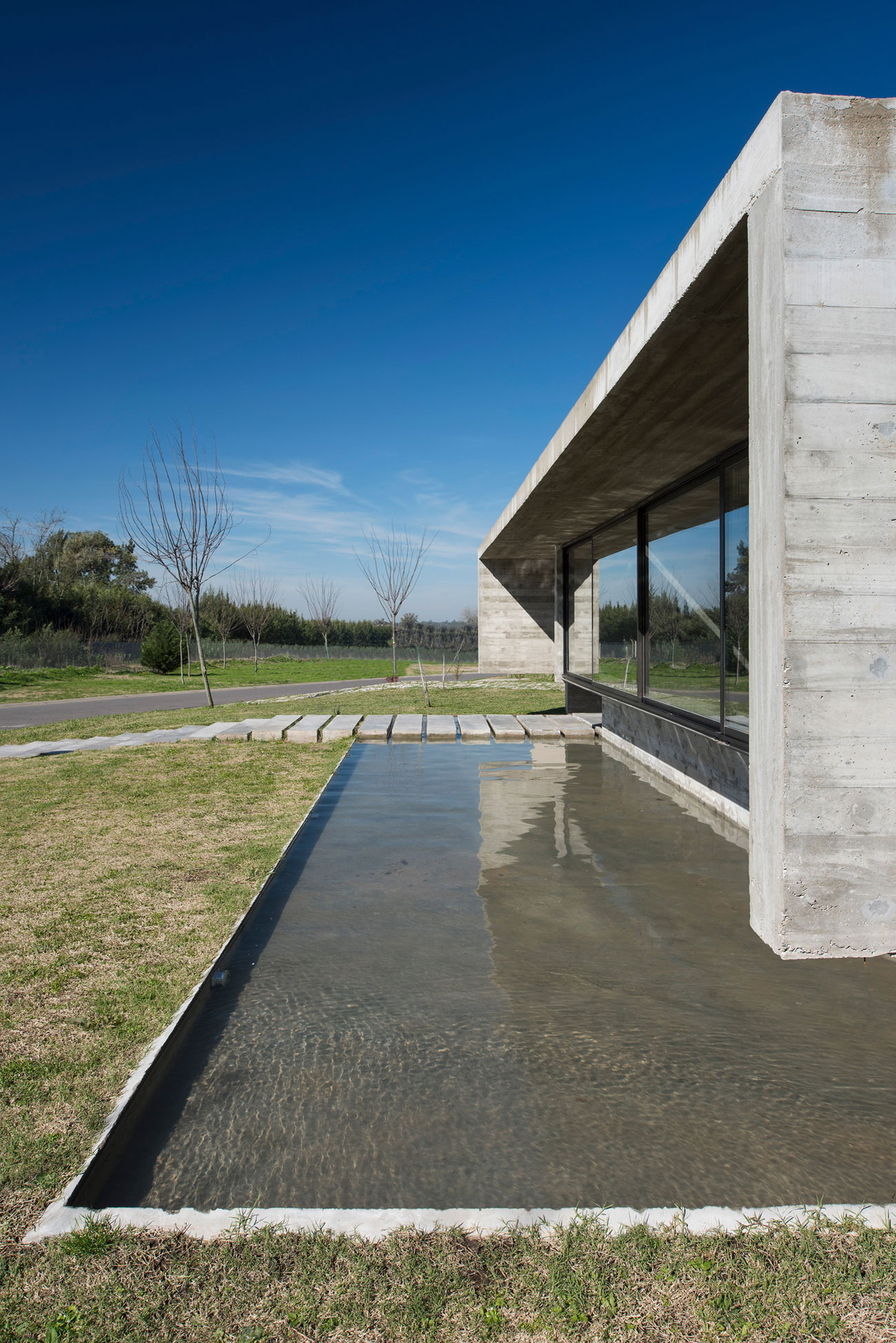 Spectacular Concrete House Surrounded by Fields and Vegetation-8