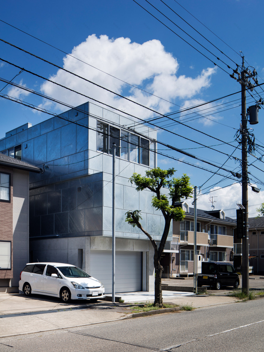 Galvanised steel panels cover irregularly stacked volumes of Japanese townhouse-2