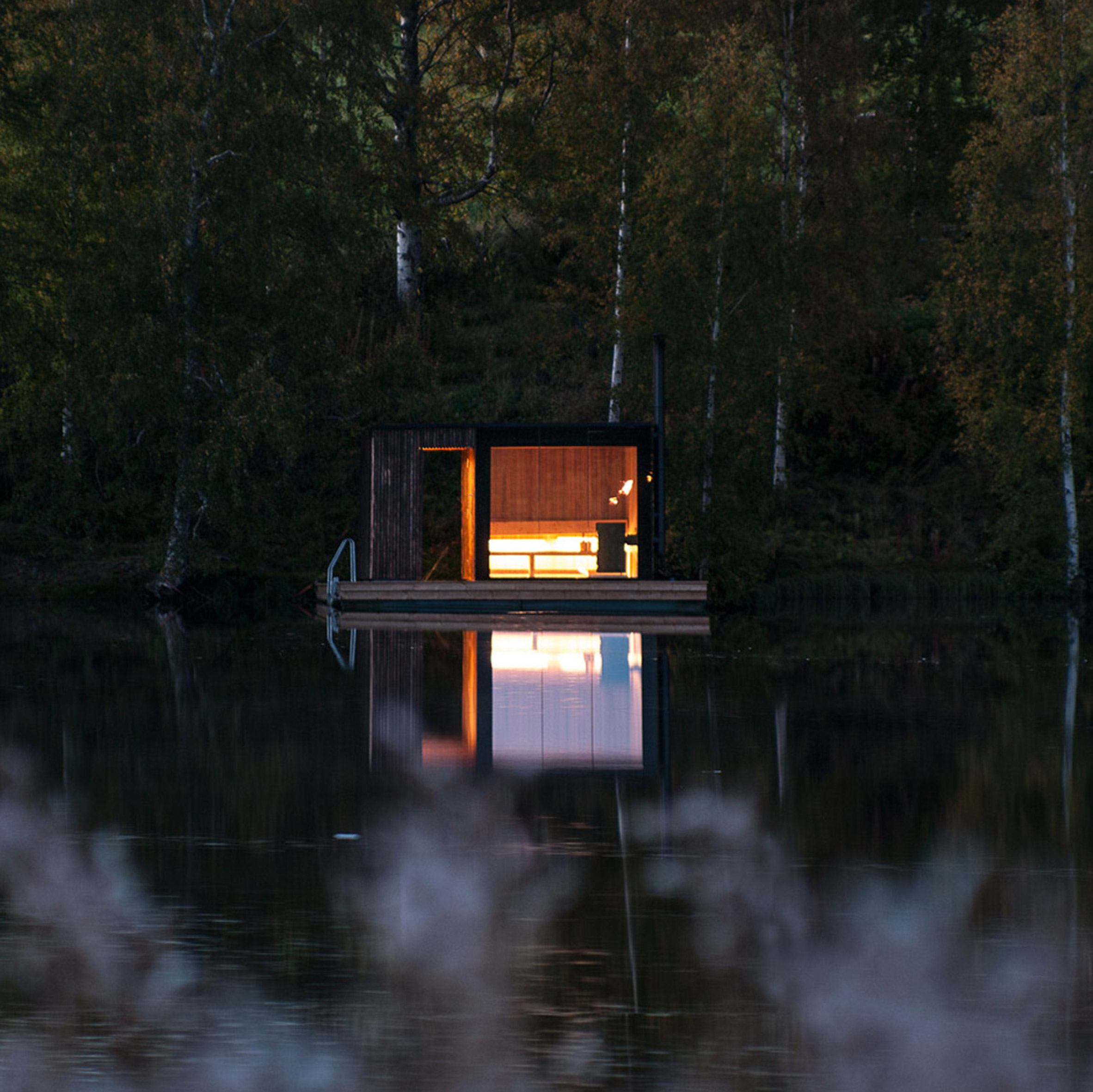 Small Architecture Workshop's charred-wood sauna floats on Swedish lake-0
