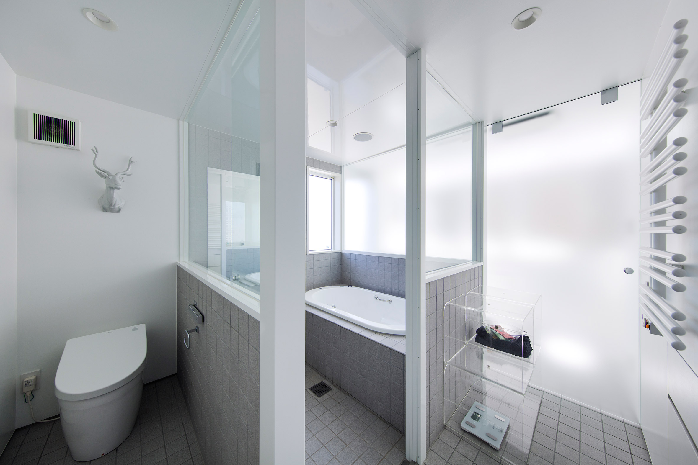 Galvanised steel panels cover irregularly stacked volumes of Japanese townhouse-24