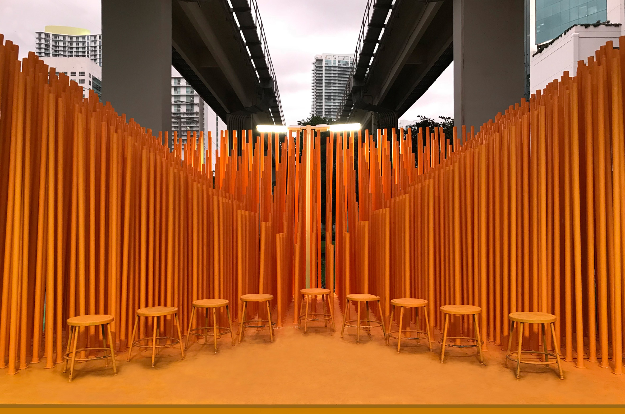 Architecture students install bright orange stage below Miami transit station-4