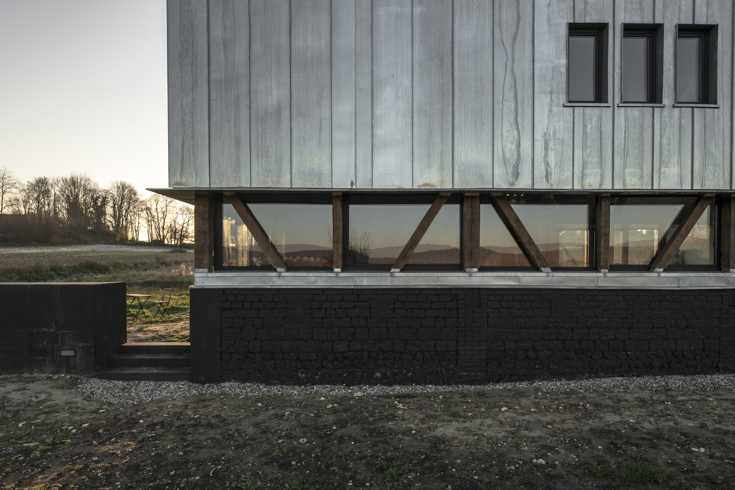 Antonin Ziegler covers abandoned barn in zinc plates to create rustic home in northern France-5