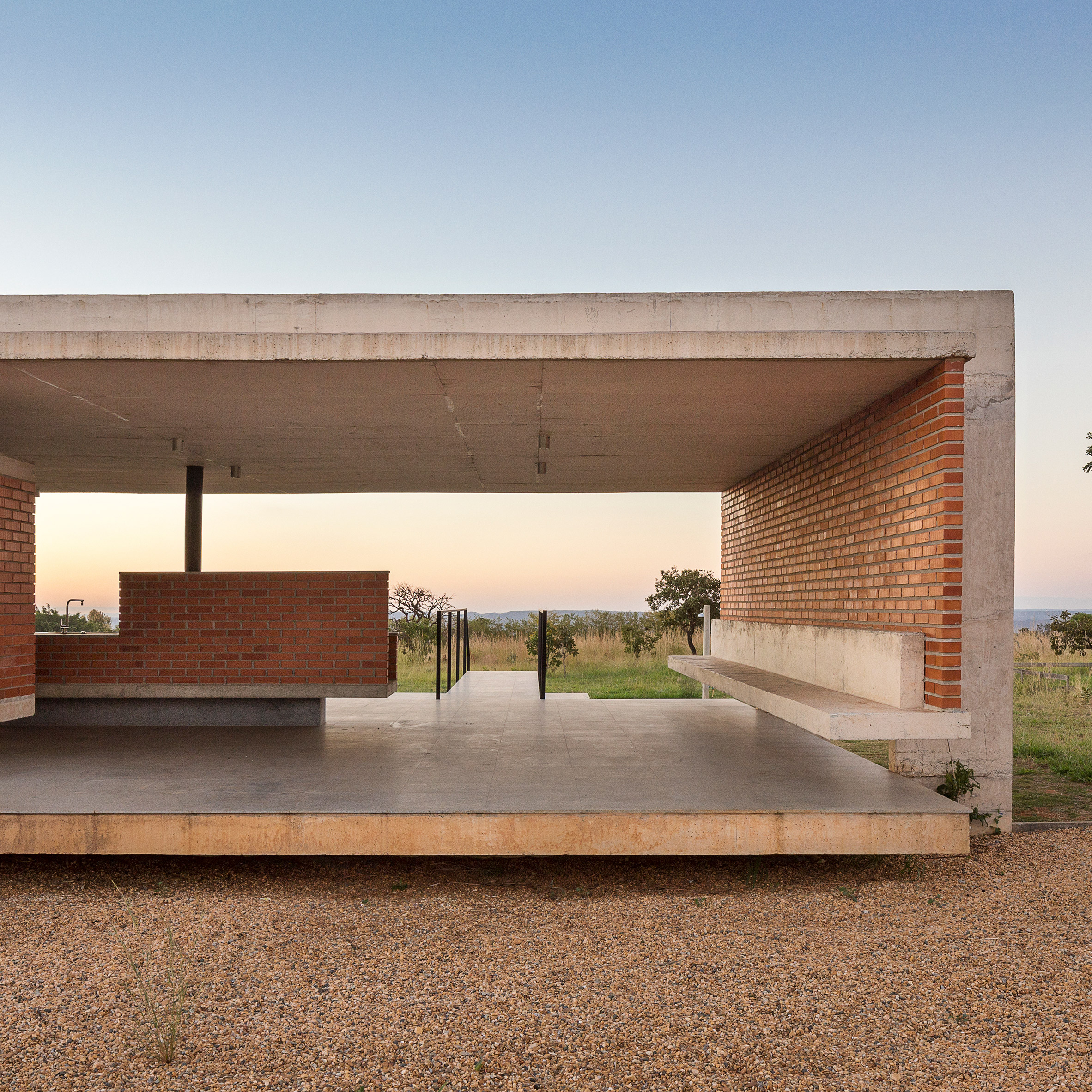 Concrete frame cradles brickwork walls of Bloco Arquitetos' rural Brasília residence-0