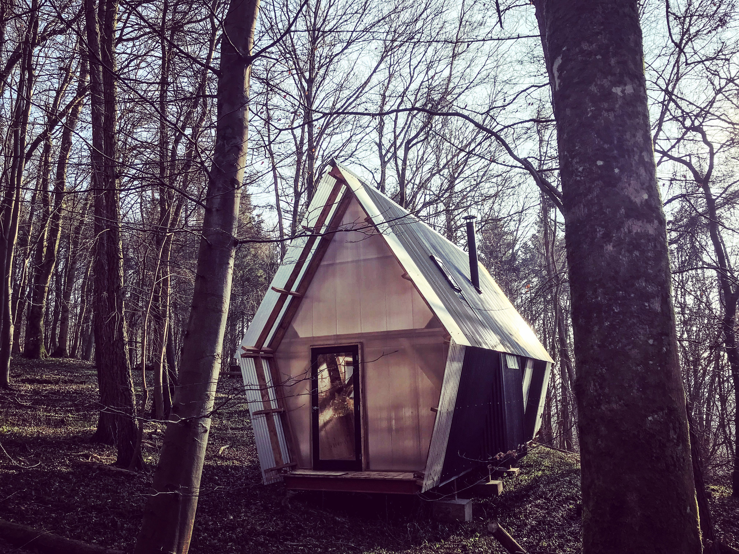 Low-cost micro home is made from timber and scavenged materials-3