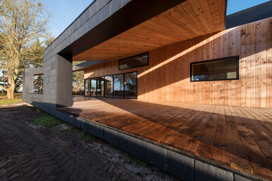 Oversized roof shelters terraces at CEBRA's Danish summer house-8