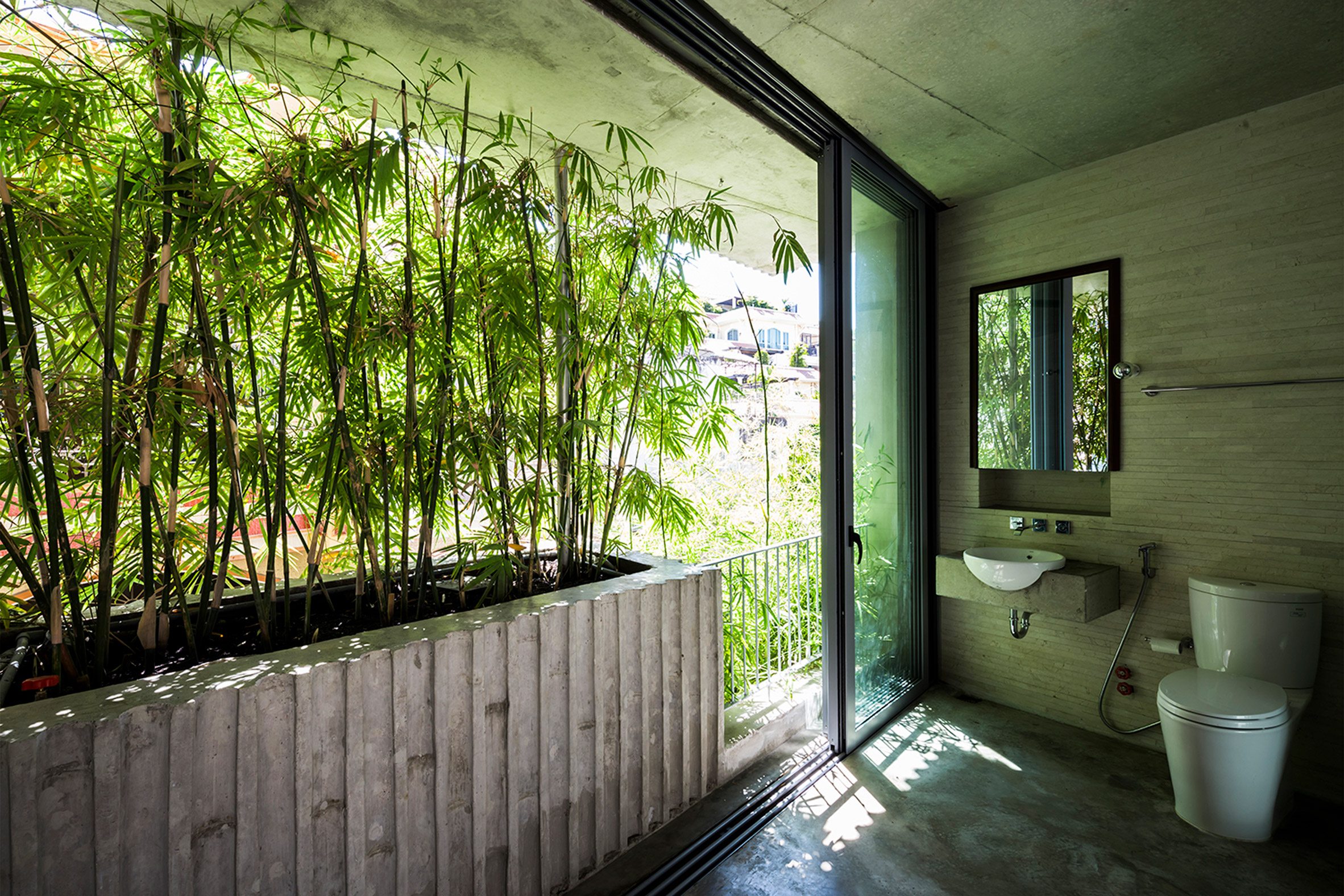 Vo Trong Nghia fronts narrow house in Vietnam with huge bamboo plant boxes-10