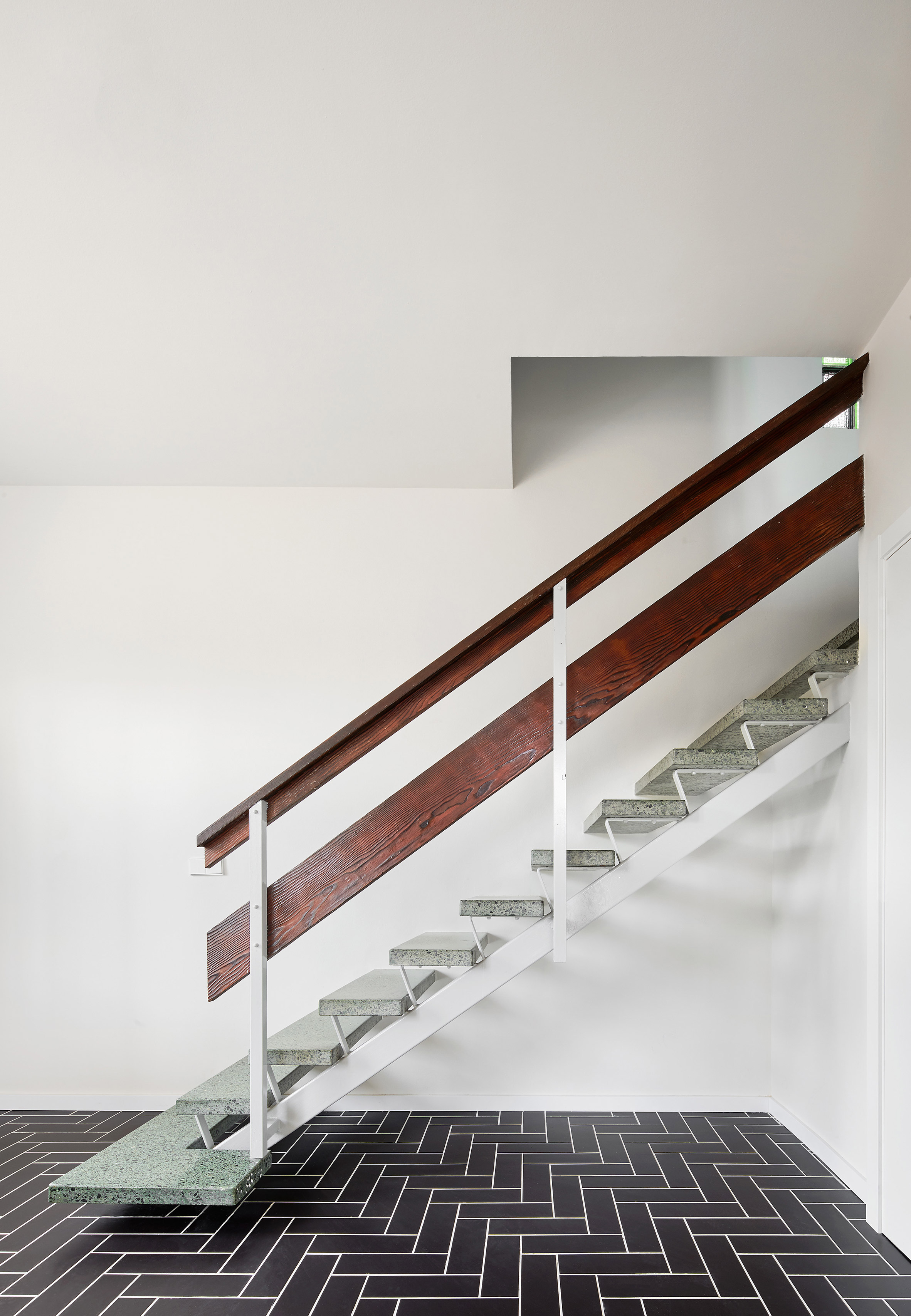 Revamped Barcelona house features herringbone floors and a covert dining area-11