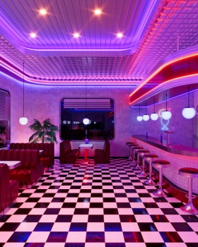 Retro diner interior with jukebox and arcade machine.