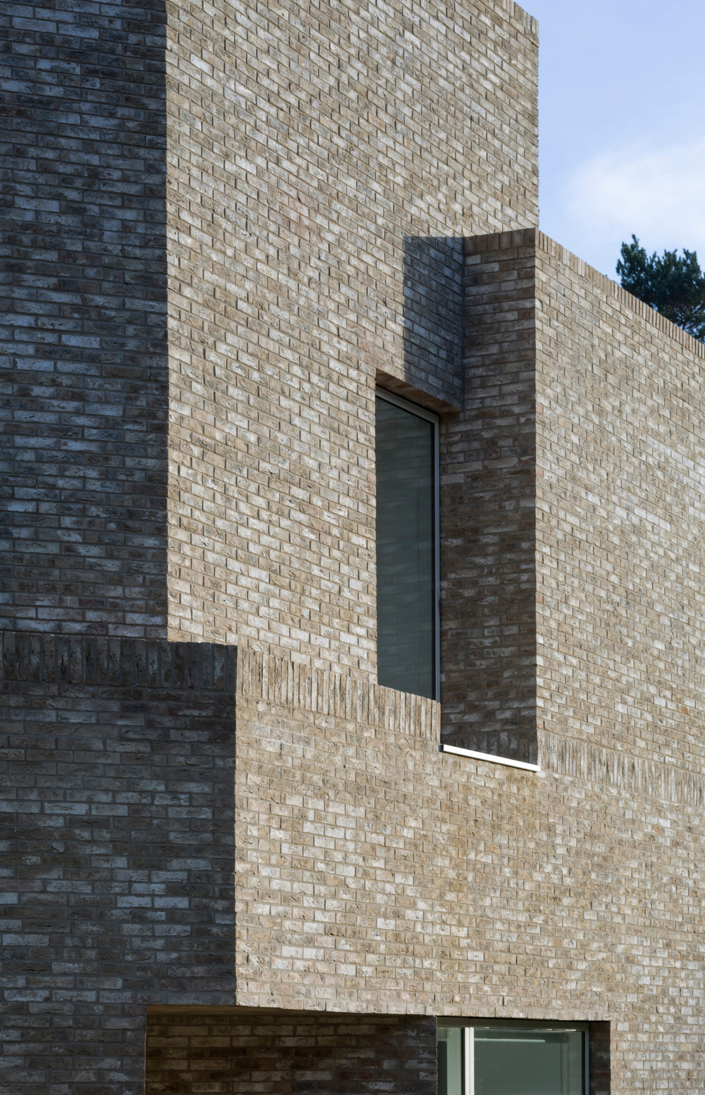 Geometric brick-clad boarding house by MICA references its neighbours-15