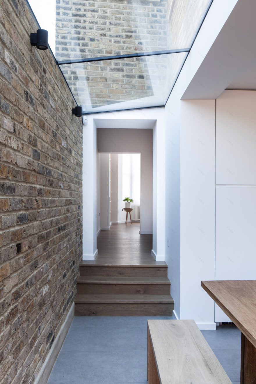 Mulroy Architects extends house with angled skylights and glass passage-12
