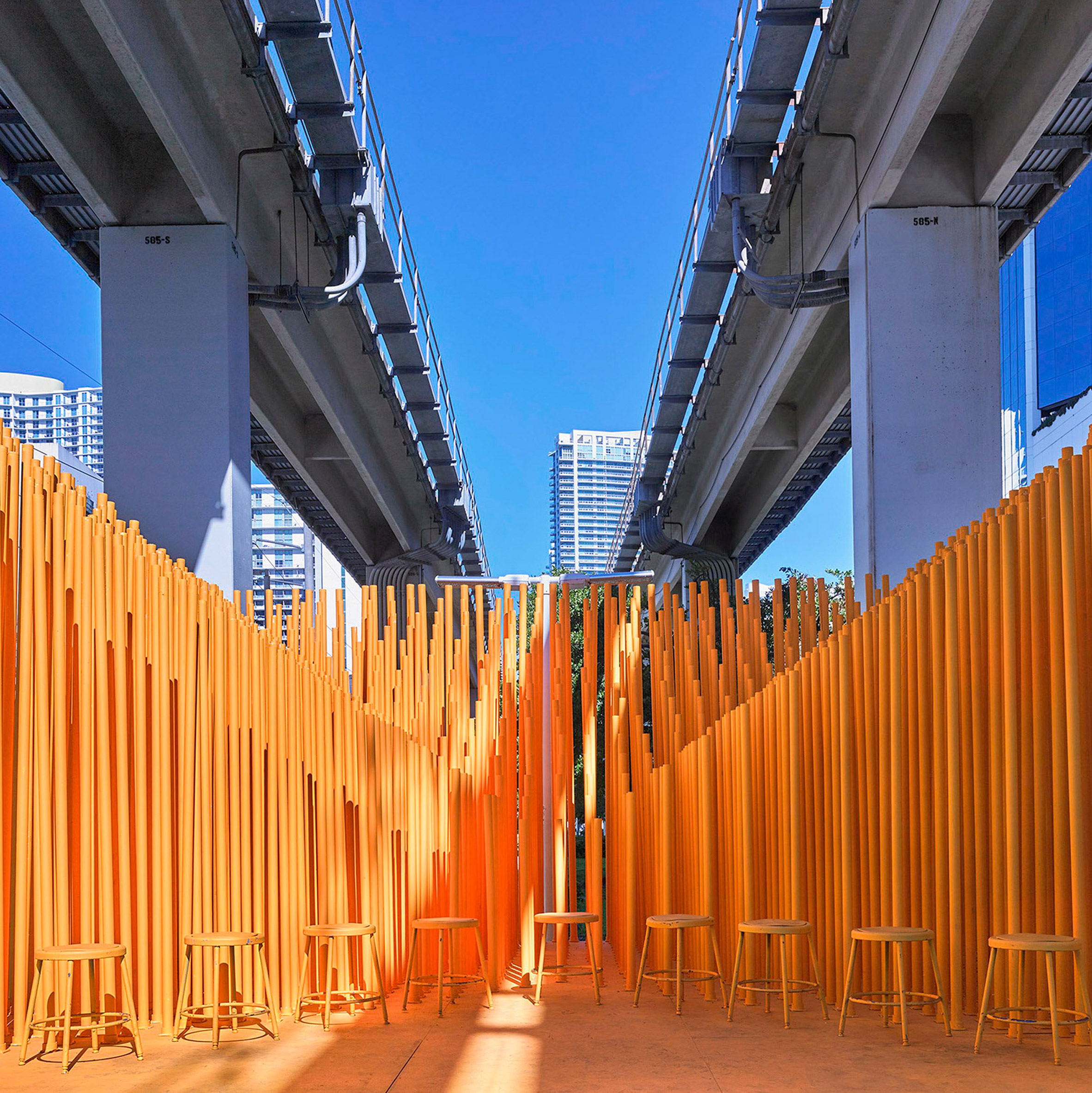 Architecture students install bright orange stage below Miami transit station-0