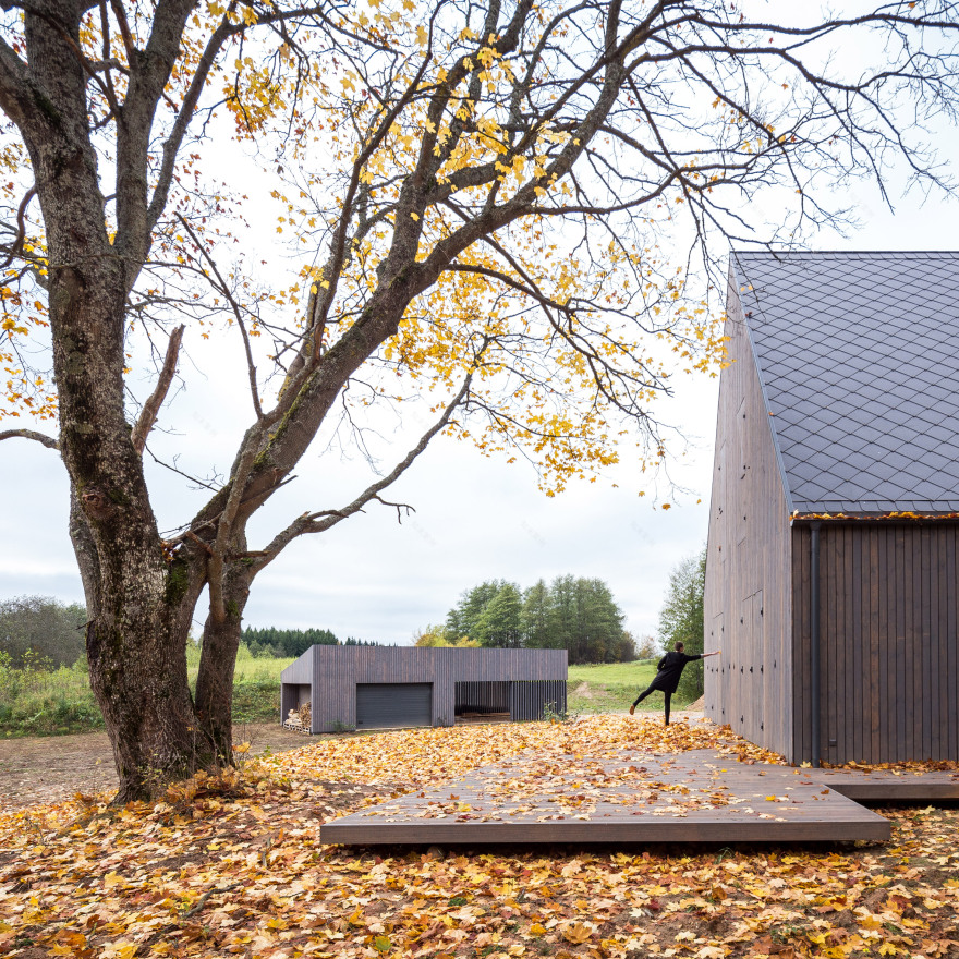 Aketuri Architektai conceals windows and doors behind large timber shutters at Lithuanian lakeside retreat-10