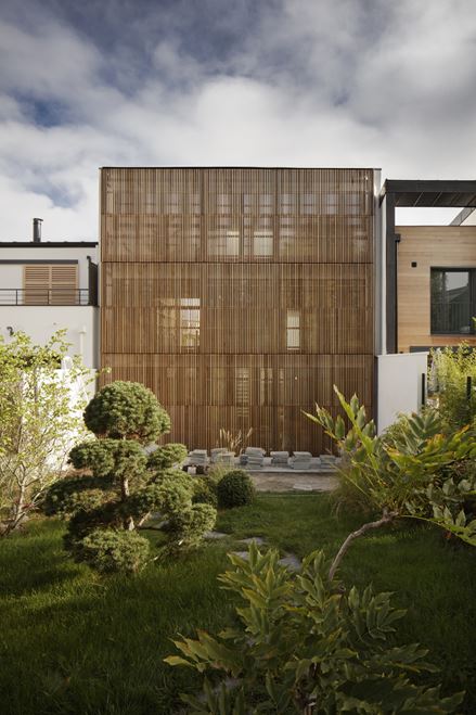 Home with Vertical Shutters Built in a Village Garden-8