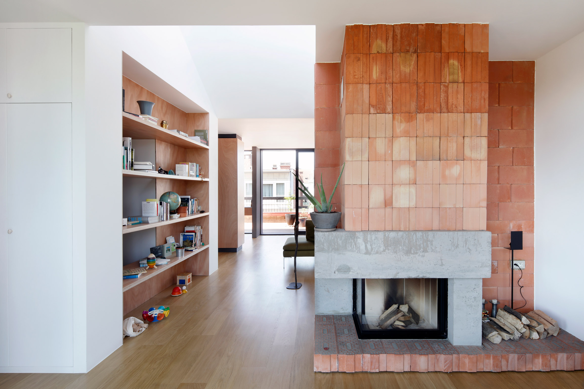 Alvar Aalto inspired the orange fireplace in this Brussels roof extension-5