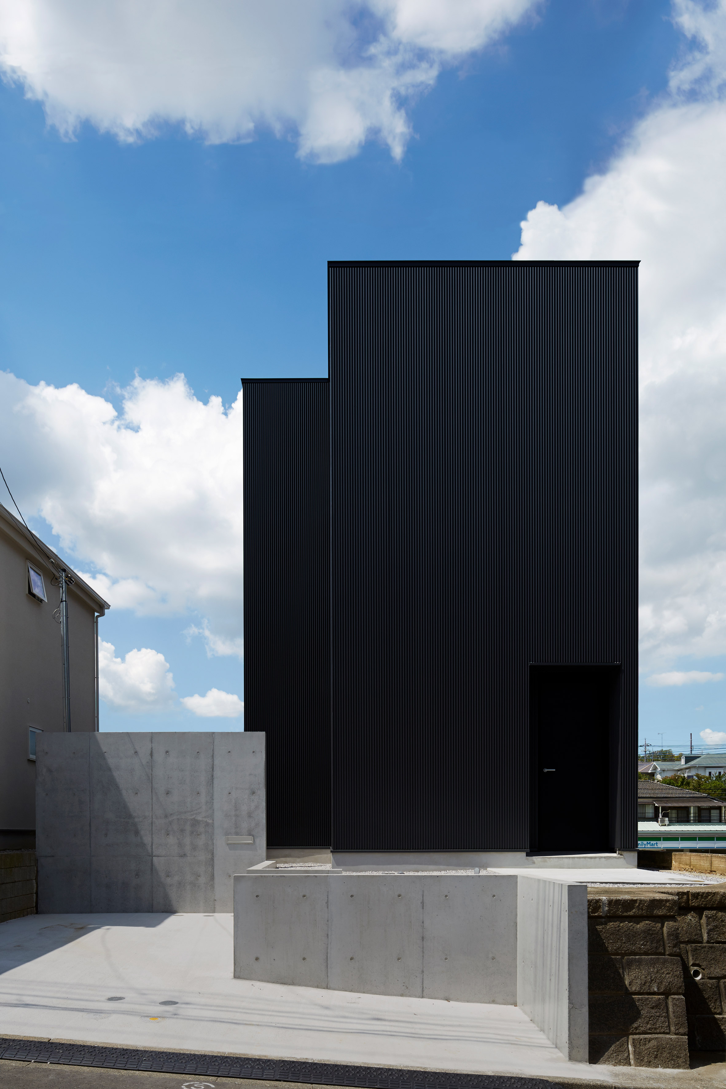 Black corrugated metal encases loft-inspired interiors of Japanese house by TakaTina-2