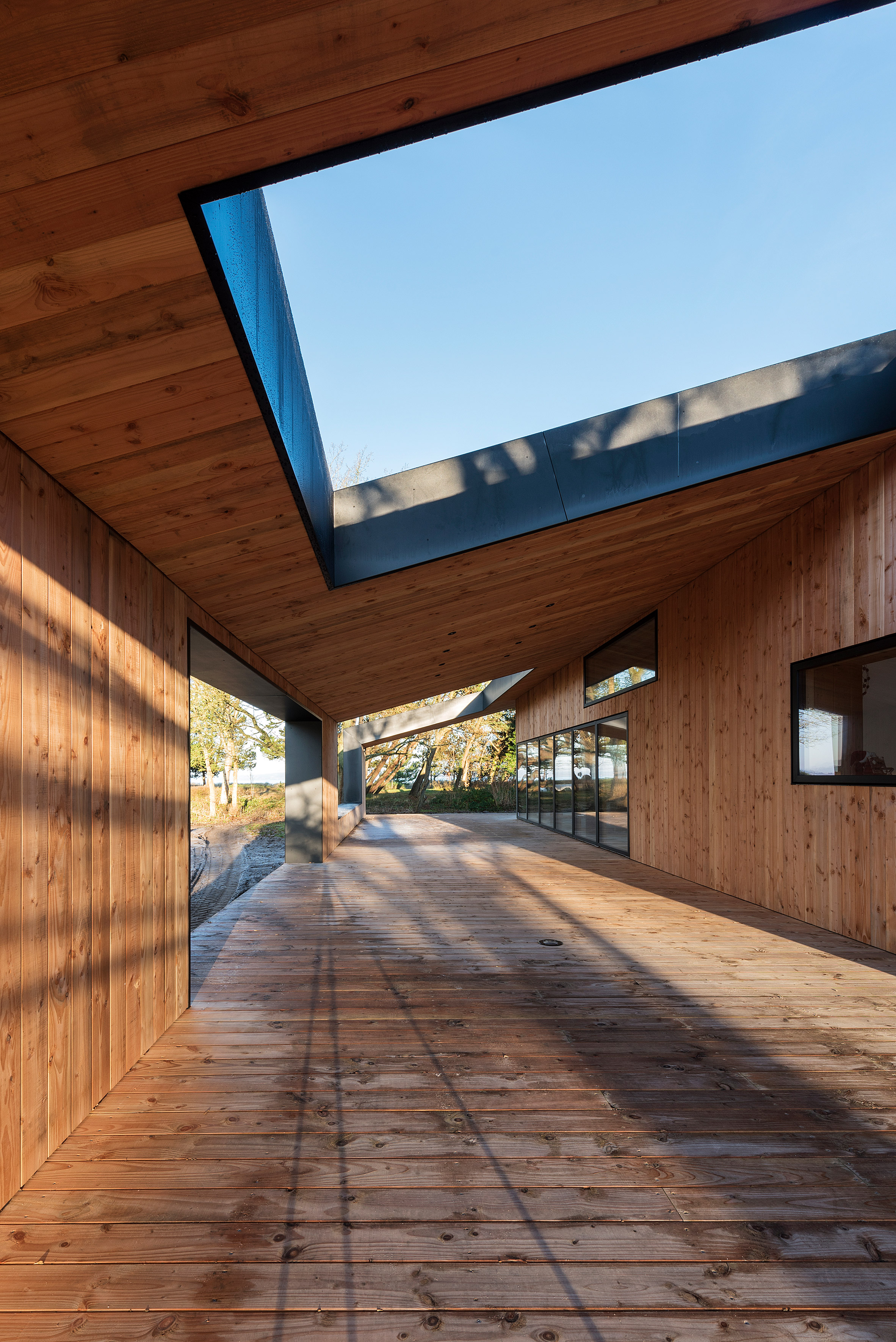 Oversized roof shelters terraces at CEBRA's Danish summer house-13