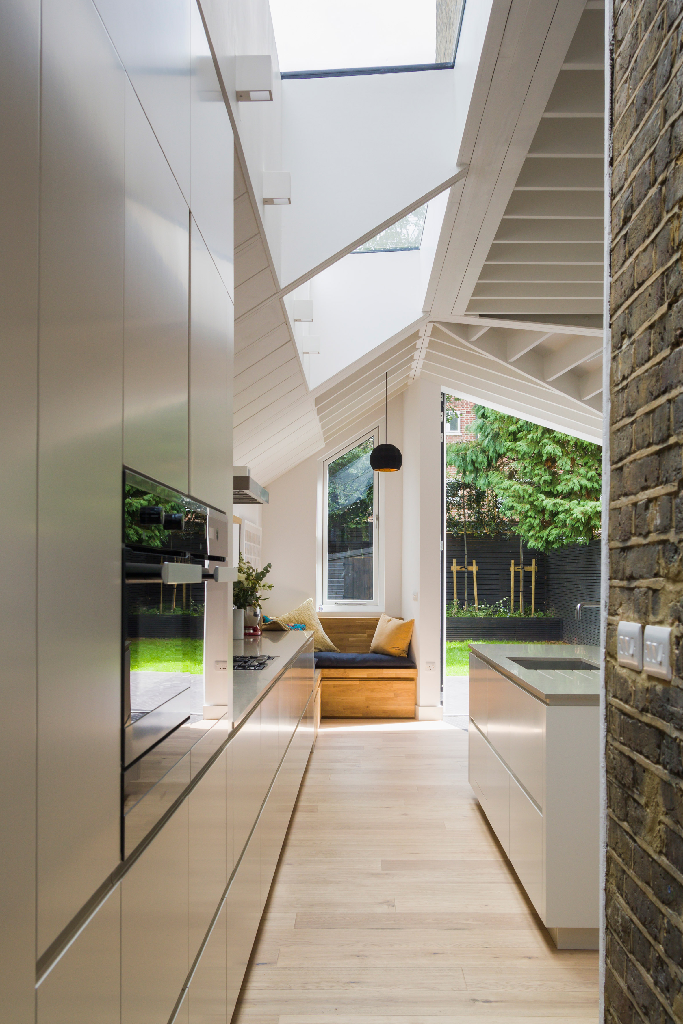 Angular doors connect tapered extension by Mustard Architects with patio-2