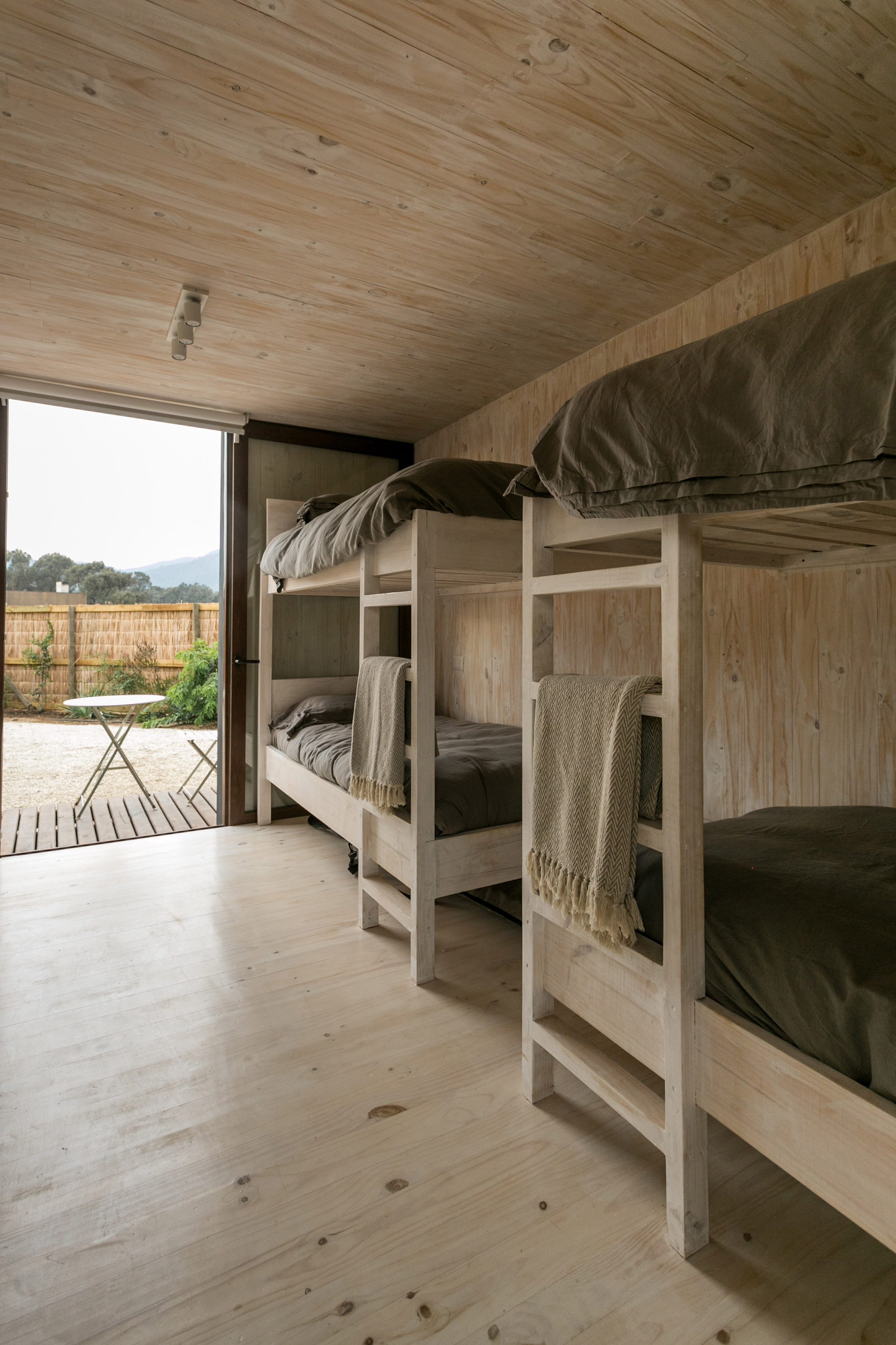 Alejandro Soffia slots two homes inside one long black building in Chile-16