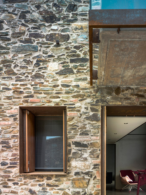 Weathered steel and stone combine in Zest Architecture's restored farmhouse-31