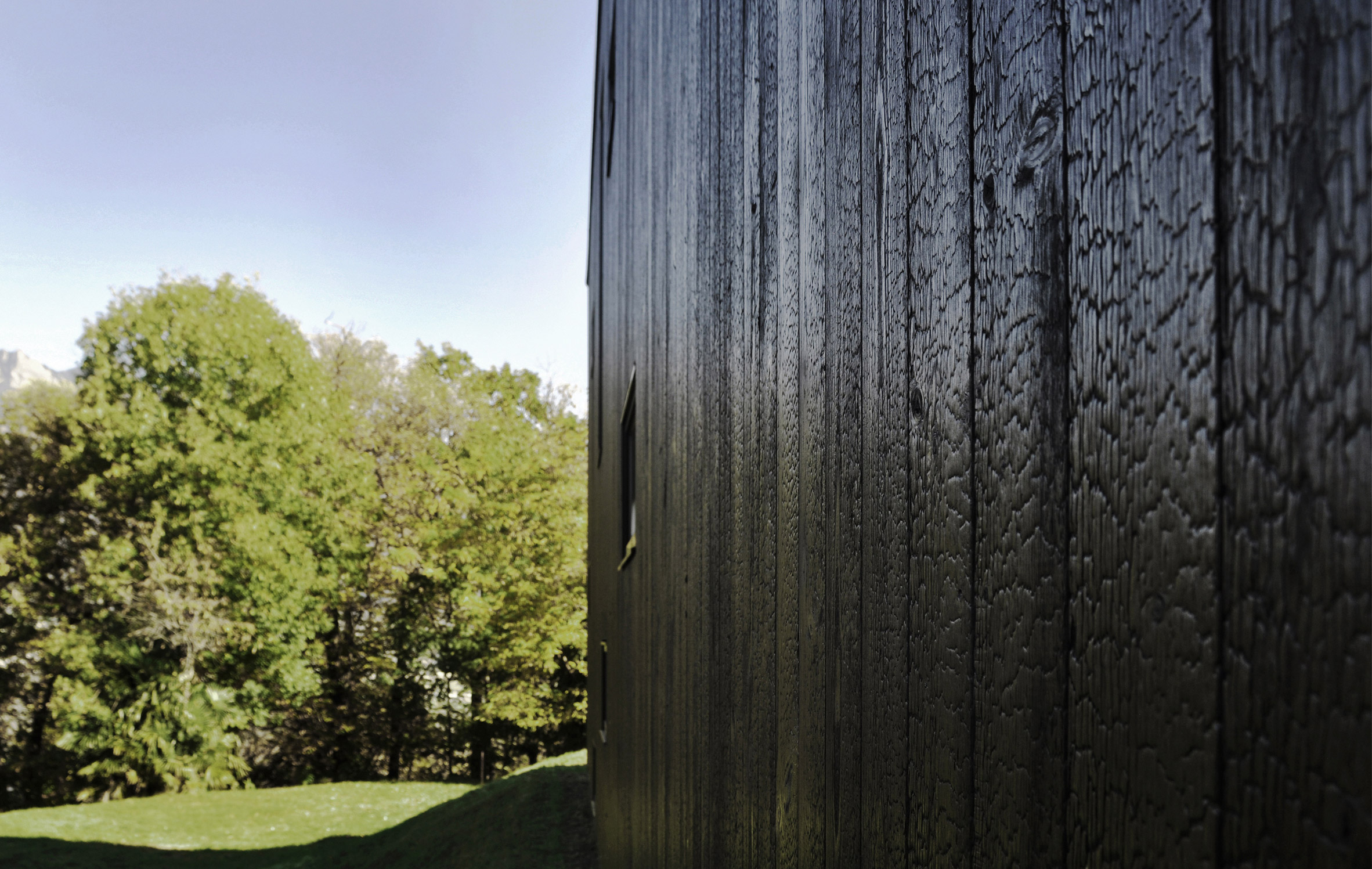 This prefabricated wooden holiday home is clad in charred timber boards-11