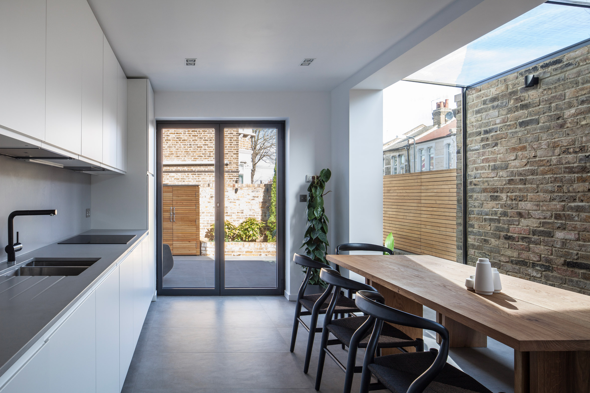 Mulroy Architects extends house with angled skylights and glass passage-5