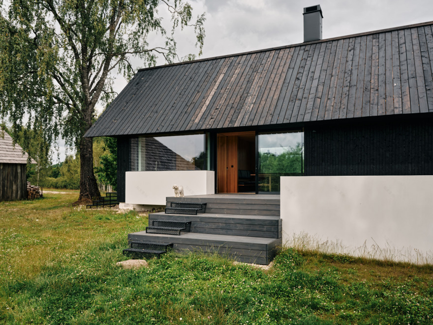 Stone cellar in Estonian forest forms base for wooden Põro House-9