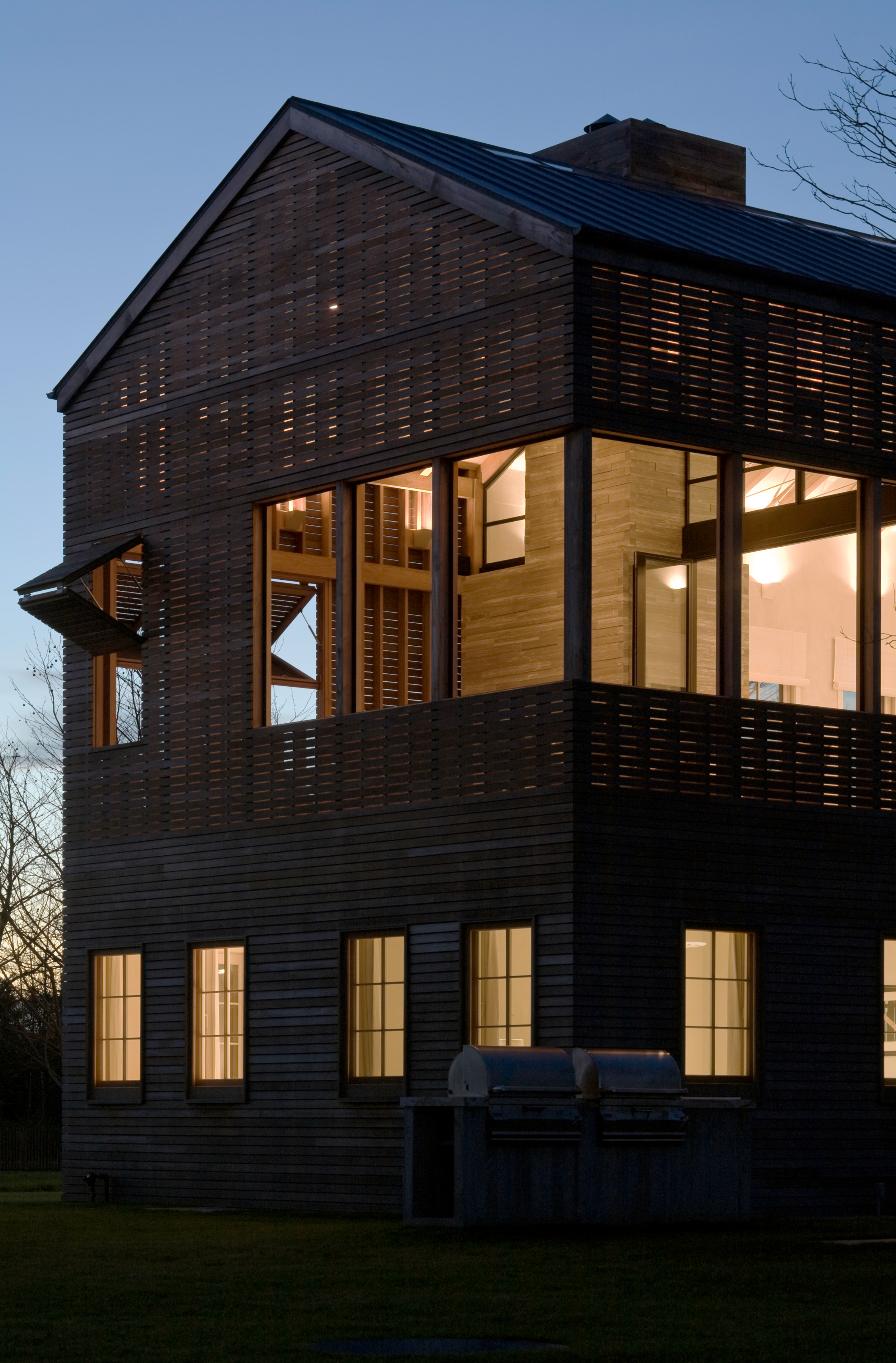 Lights glow through facades of Hamptons home by Leroy Street Studio-16