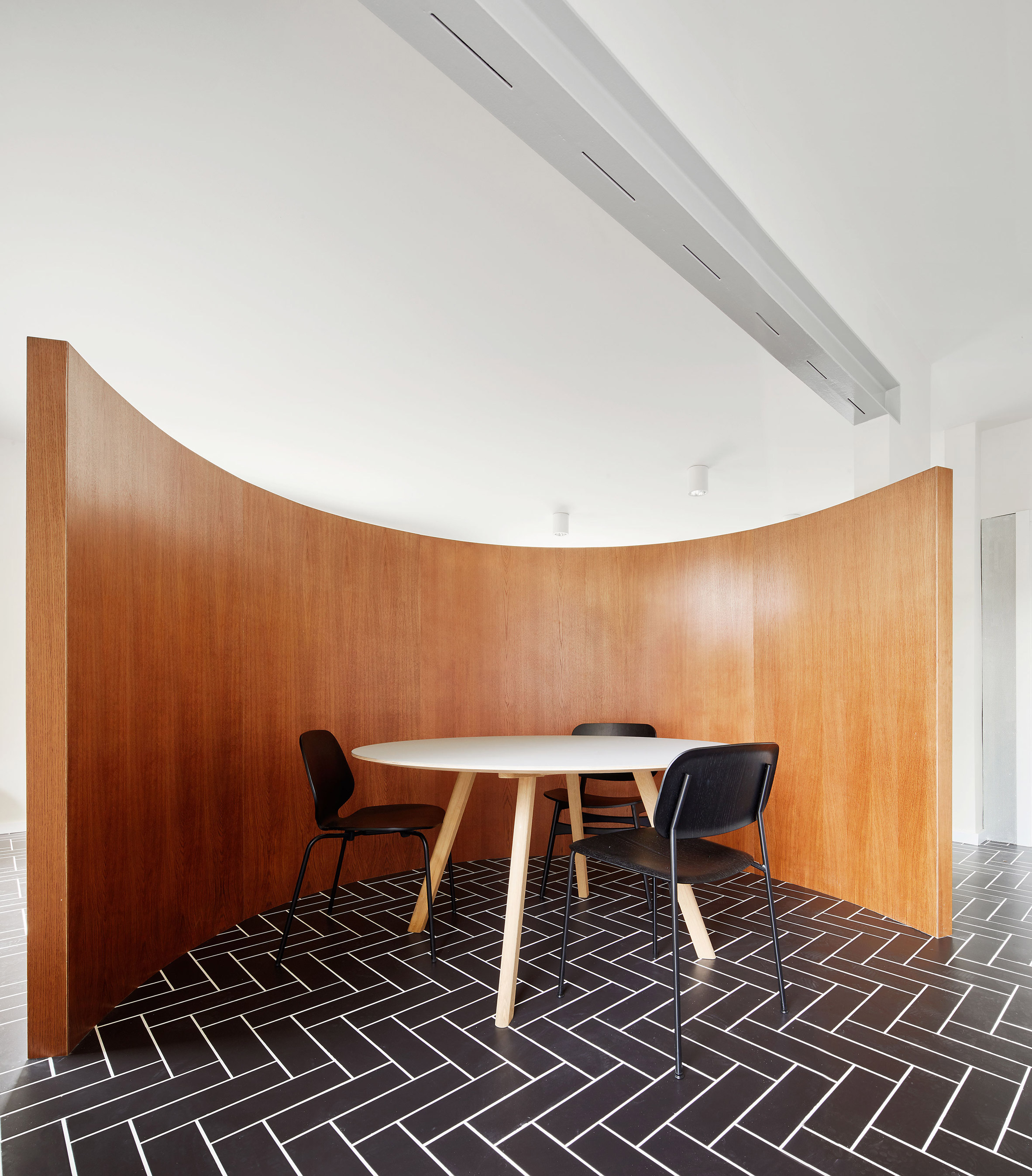 Revamped Barcelona house features herringbone floors and a covert dining area-5
