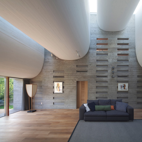 Curving roofline enhances acoustics inside house by NKS Architects-6