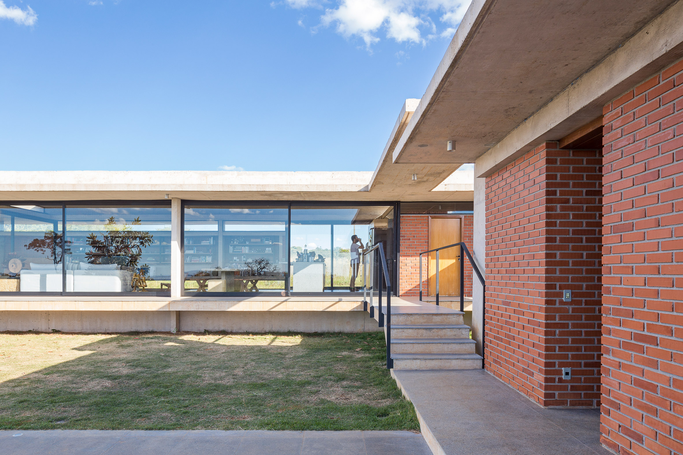 Concrete frame cradles brickwork walls of Bloco Arquitetos' rural Brasília residence-9