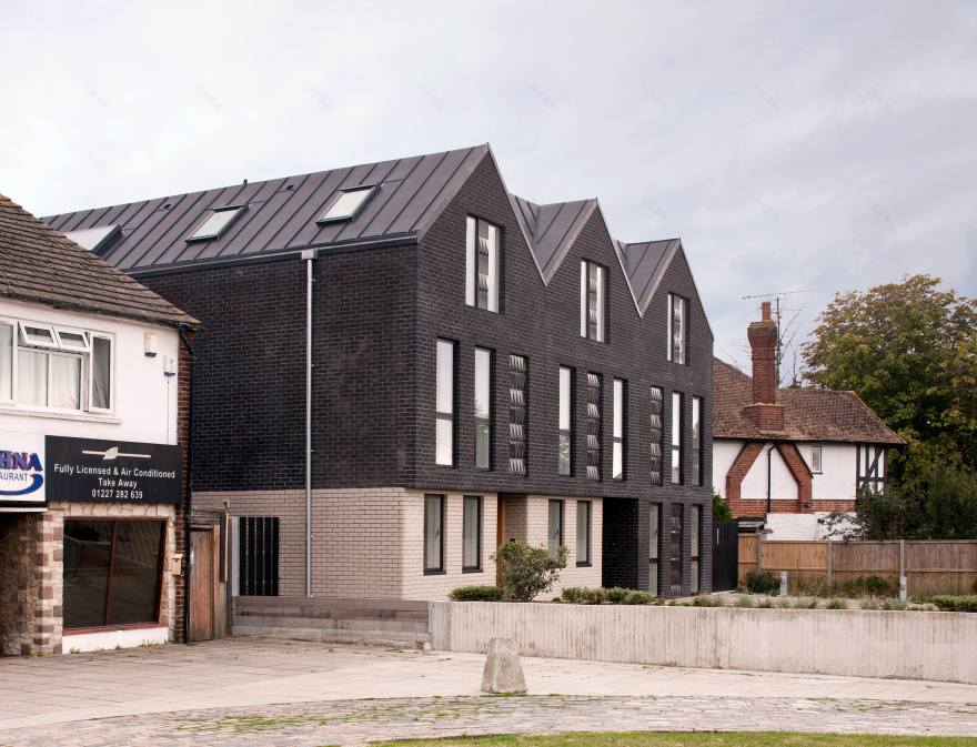Denizen Works pairs black bricks with pointy panels for Whitstable housing-5