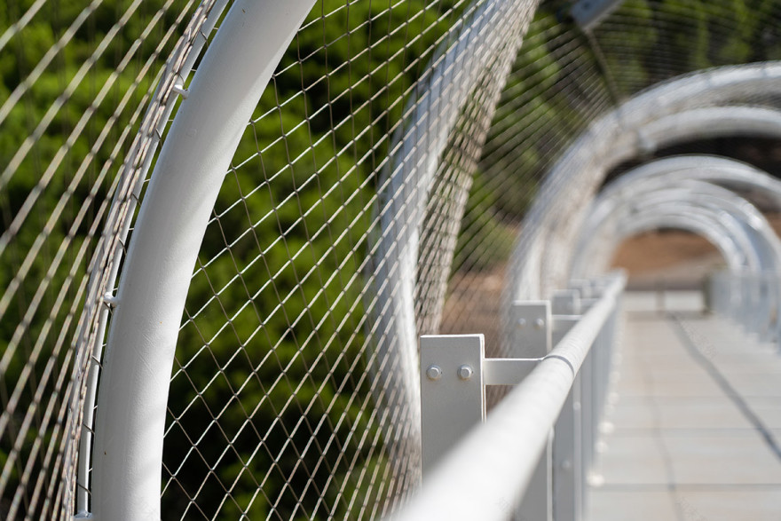 Held together by function and aesthetics: tensile mesh barriers and facades | IndesignLive-7