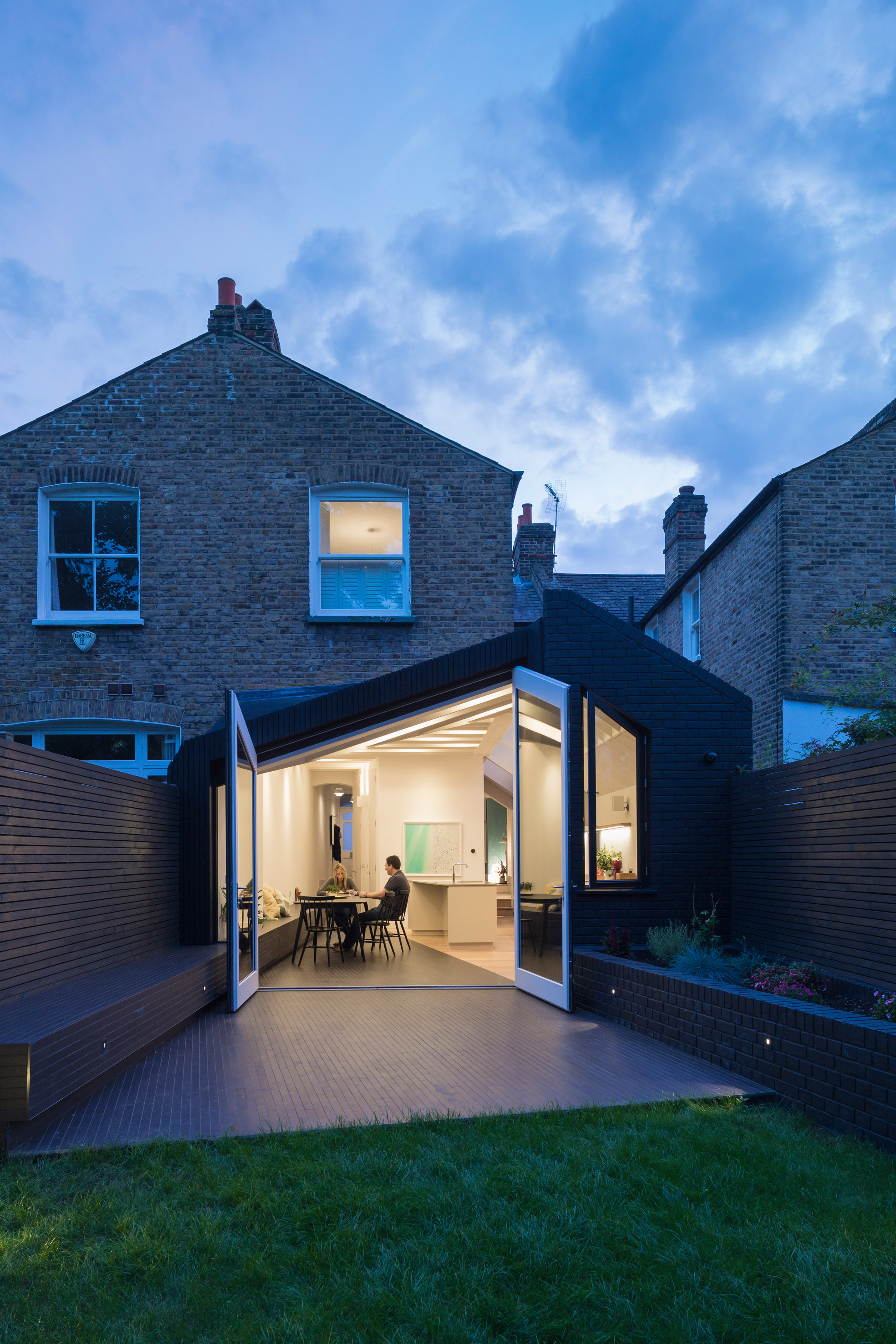 Angular doors connect tapered extension by Mustard Architects with patio-22