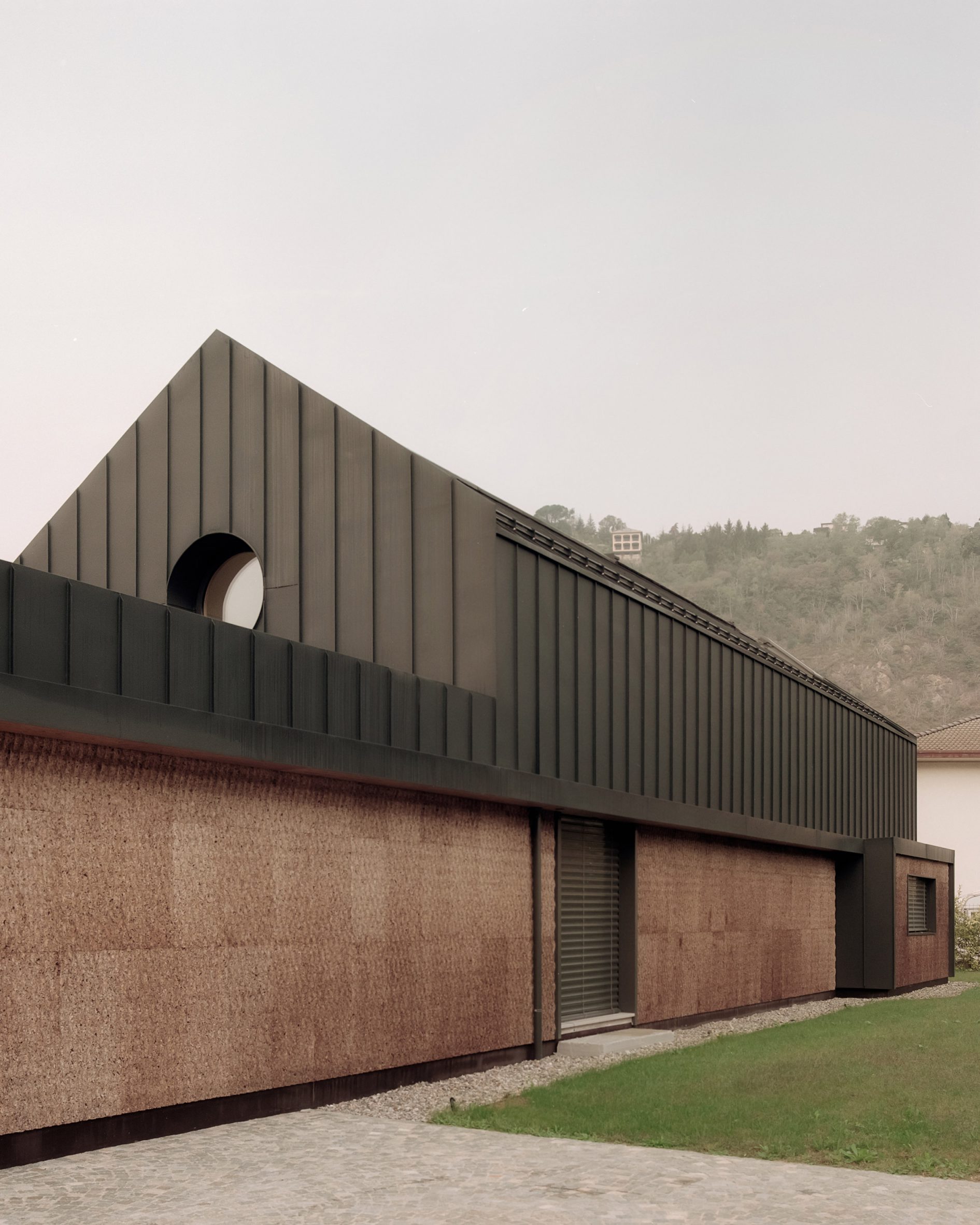 LCA Architetti nestles angular cork-clad home into Italian valley-9