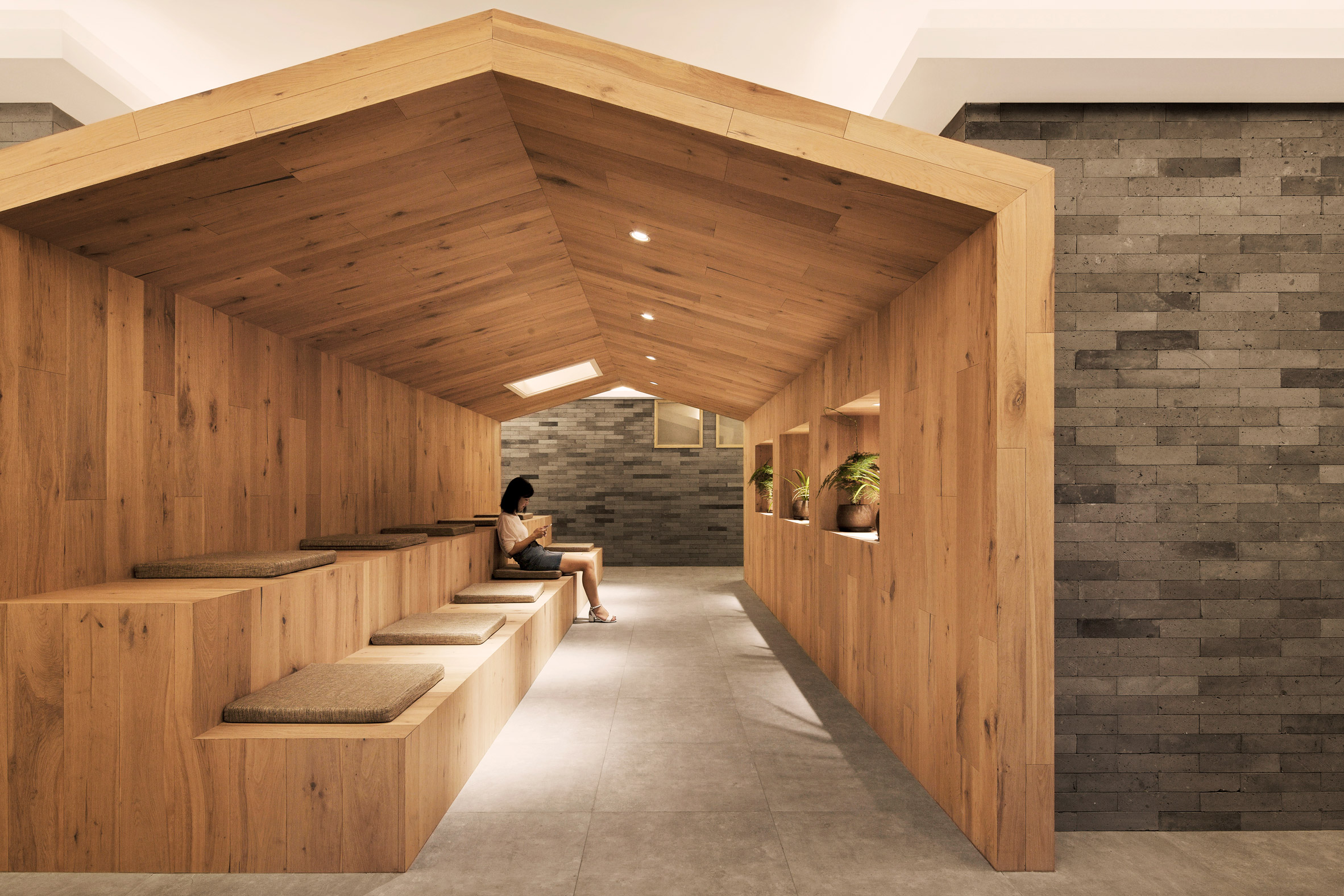 Penda inserts house-shaped opening into facade of hotel in Beijing hutong-13