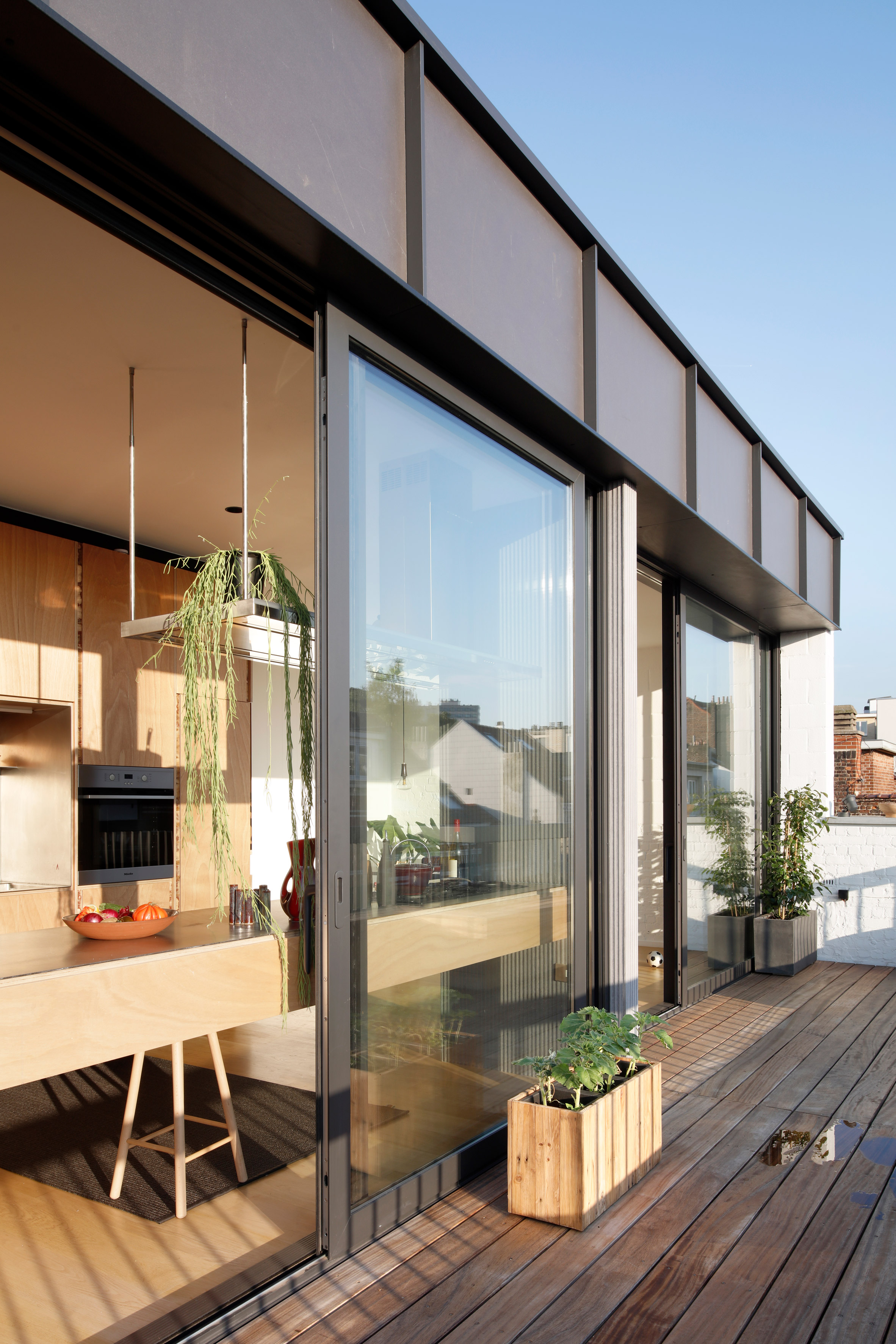 Alvar Aalto inspired the orange fireplace in this Brussels roof extension-2