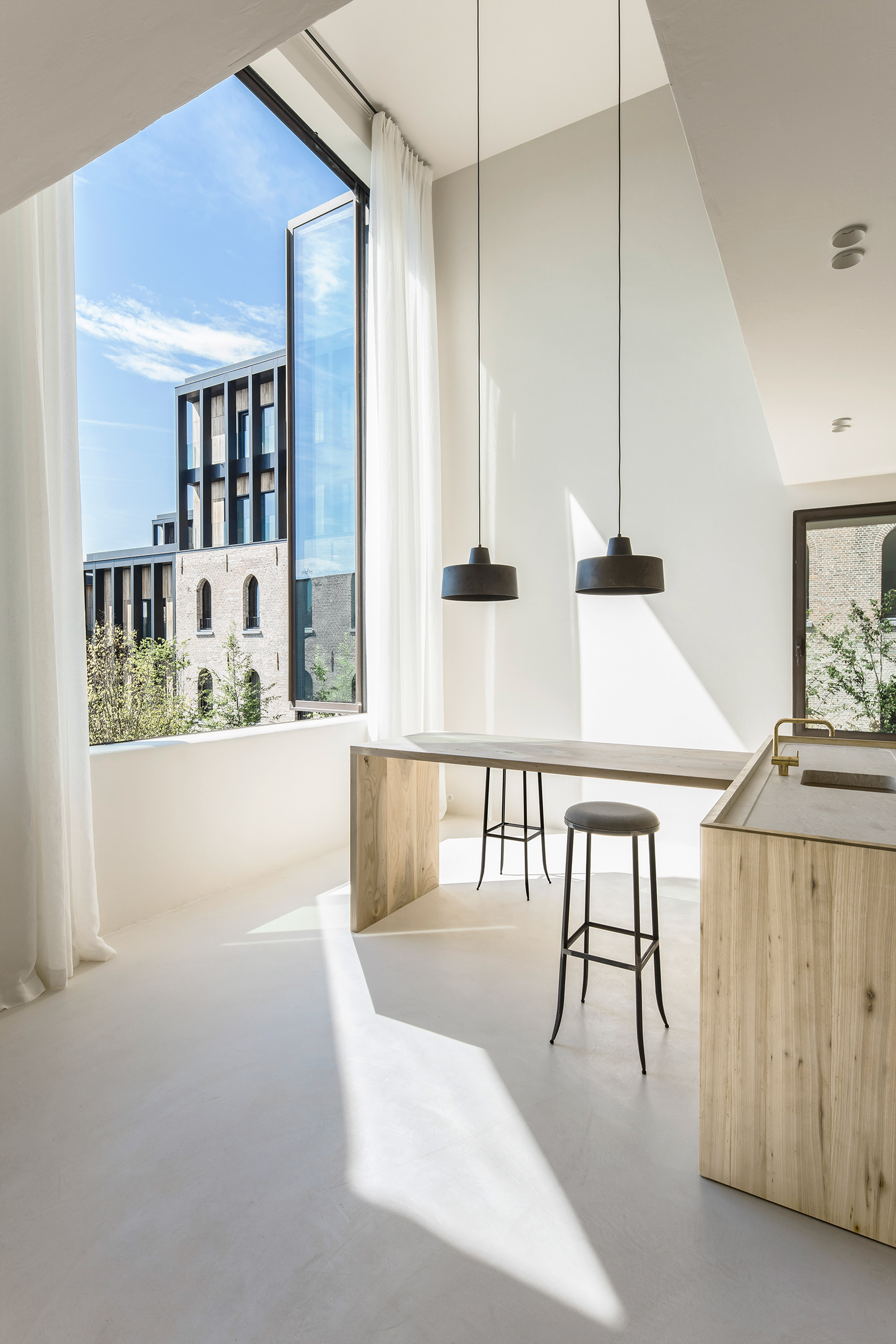 Arjaan De Feyter combines "light and warm materials" in converted brewery apartment-12