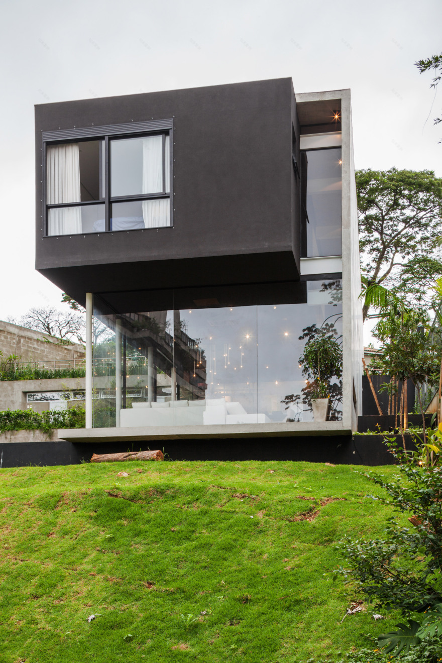 Concrete volume appears to rest on glass in Brazilian house by FGMF Arquitetos-3