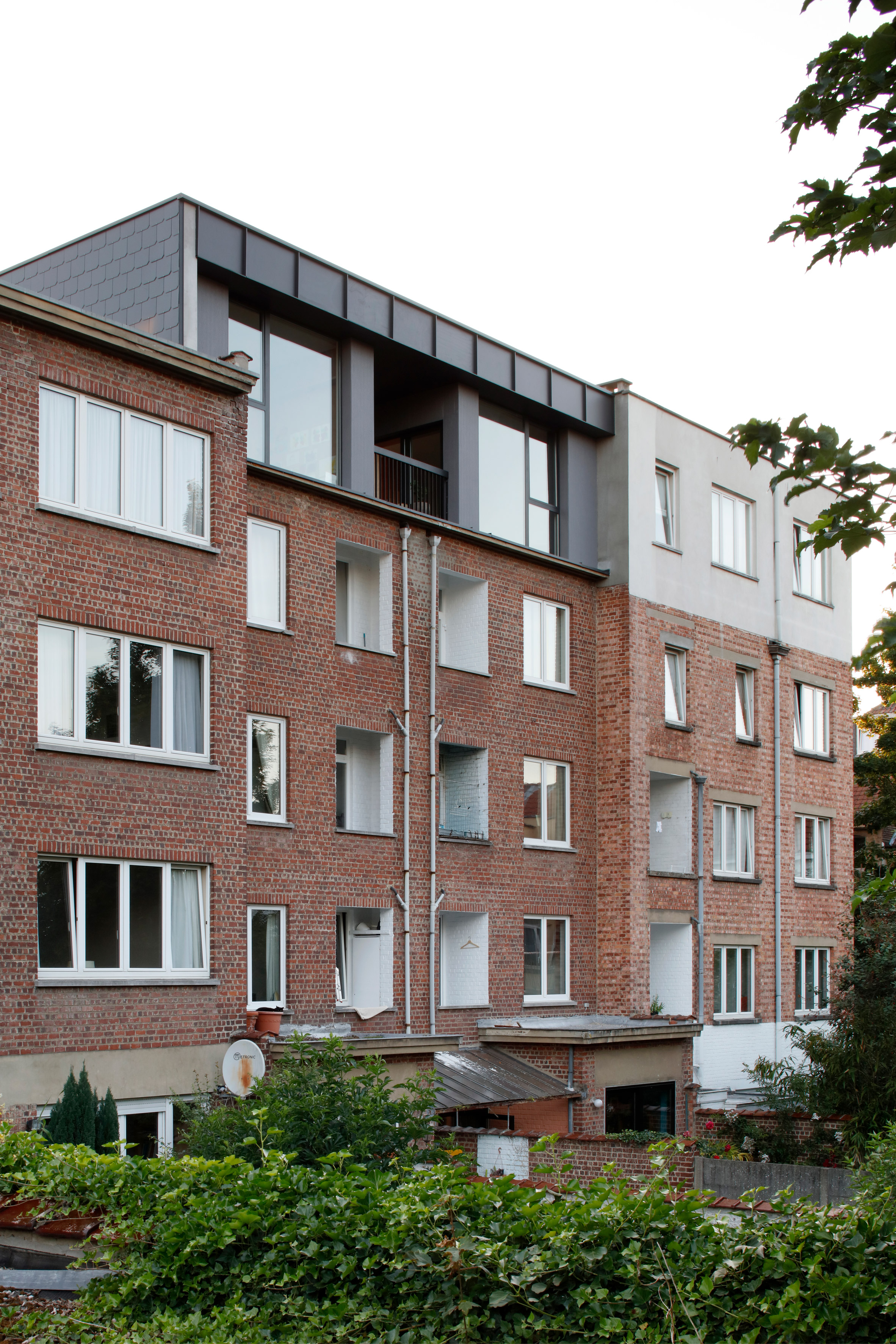 Alvar Aalto inspired the orange fireplace in this Brussels roof extension-33