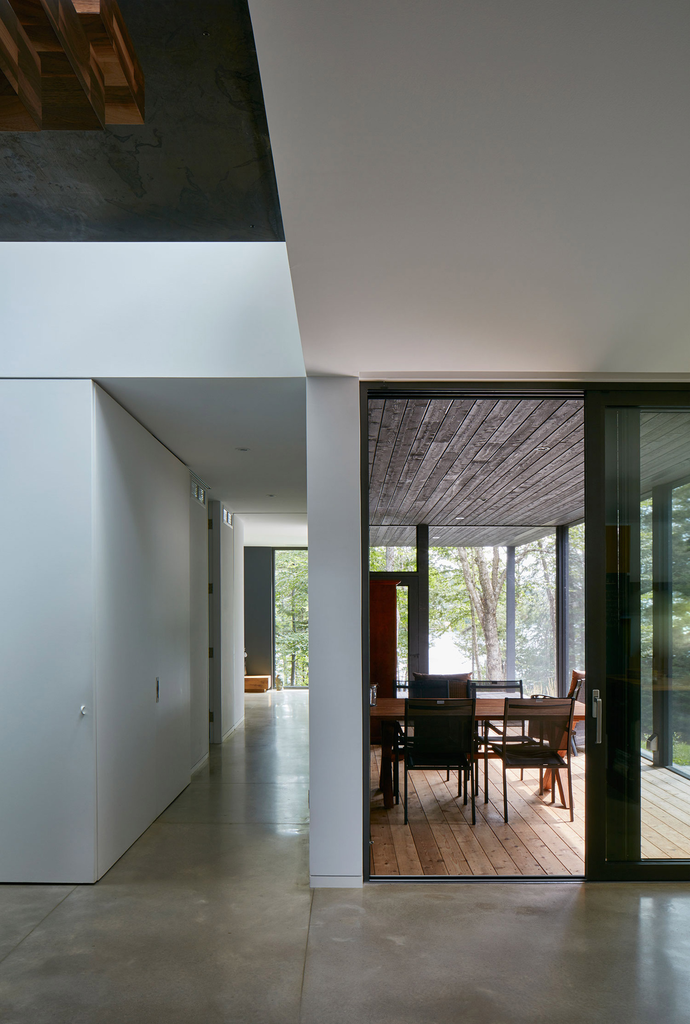 Canadian lake house by Paul Bernier features dark rusted metal cladding-10