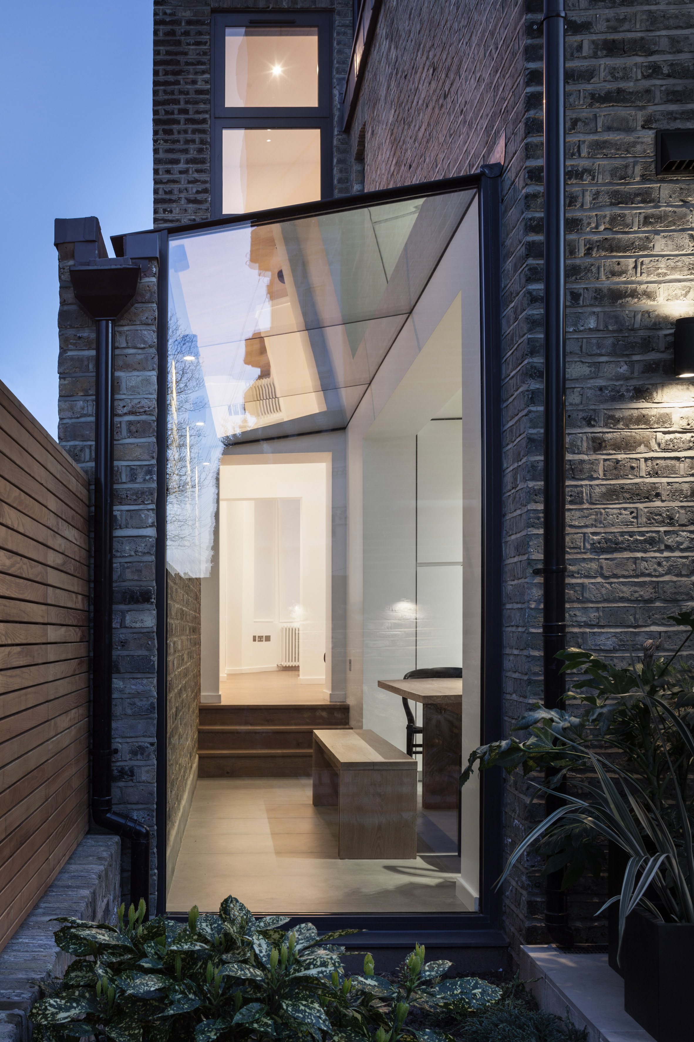 Mulroy Architects extends house with angled skylights and glass passage-18