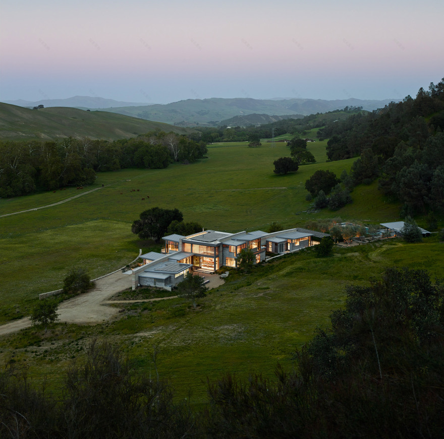 Stripey rammed-earth walls curve through holiday house in Californian walnut farm-2