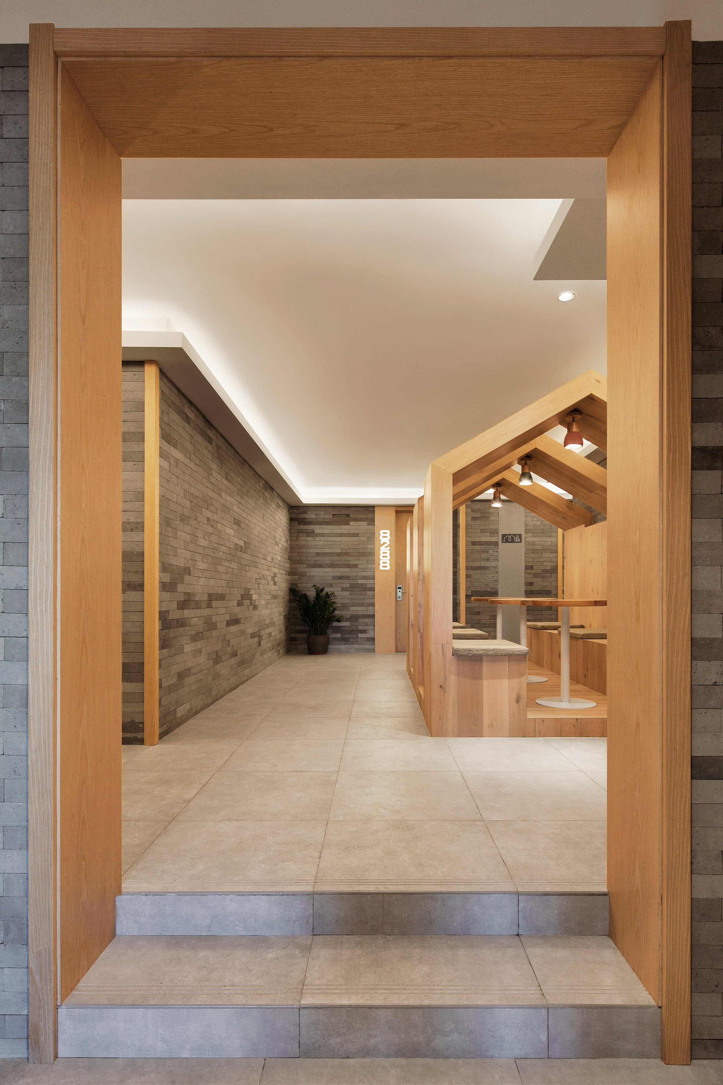 Penda inserts house-shaped opening into facade of hotel in Beijing hutong-16