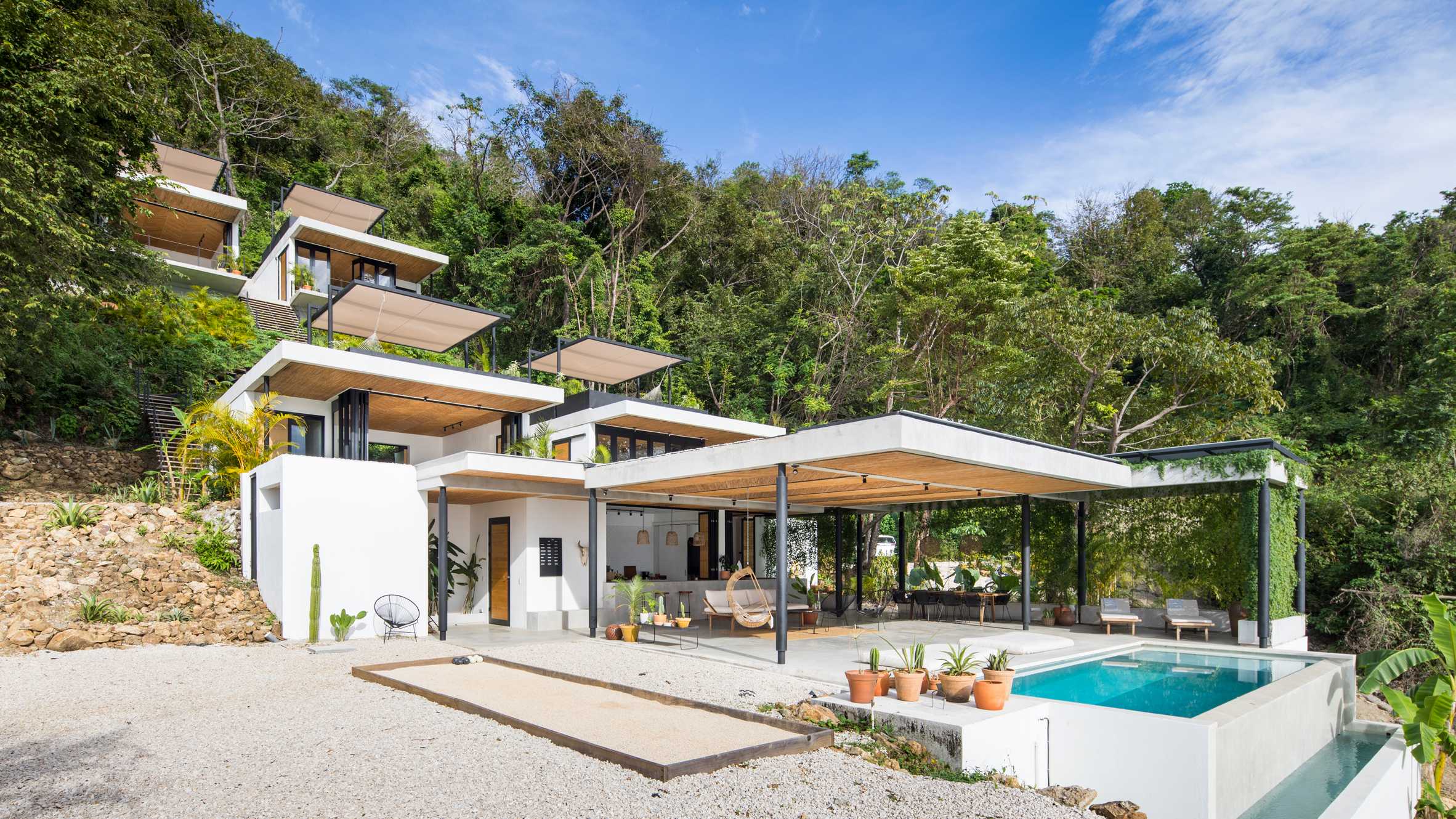 Staggered pavilions form holiday resort on lush hill in Costa Rican surf town-0