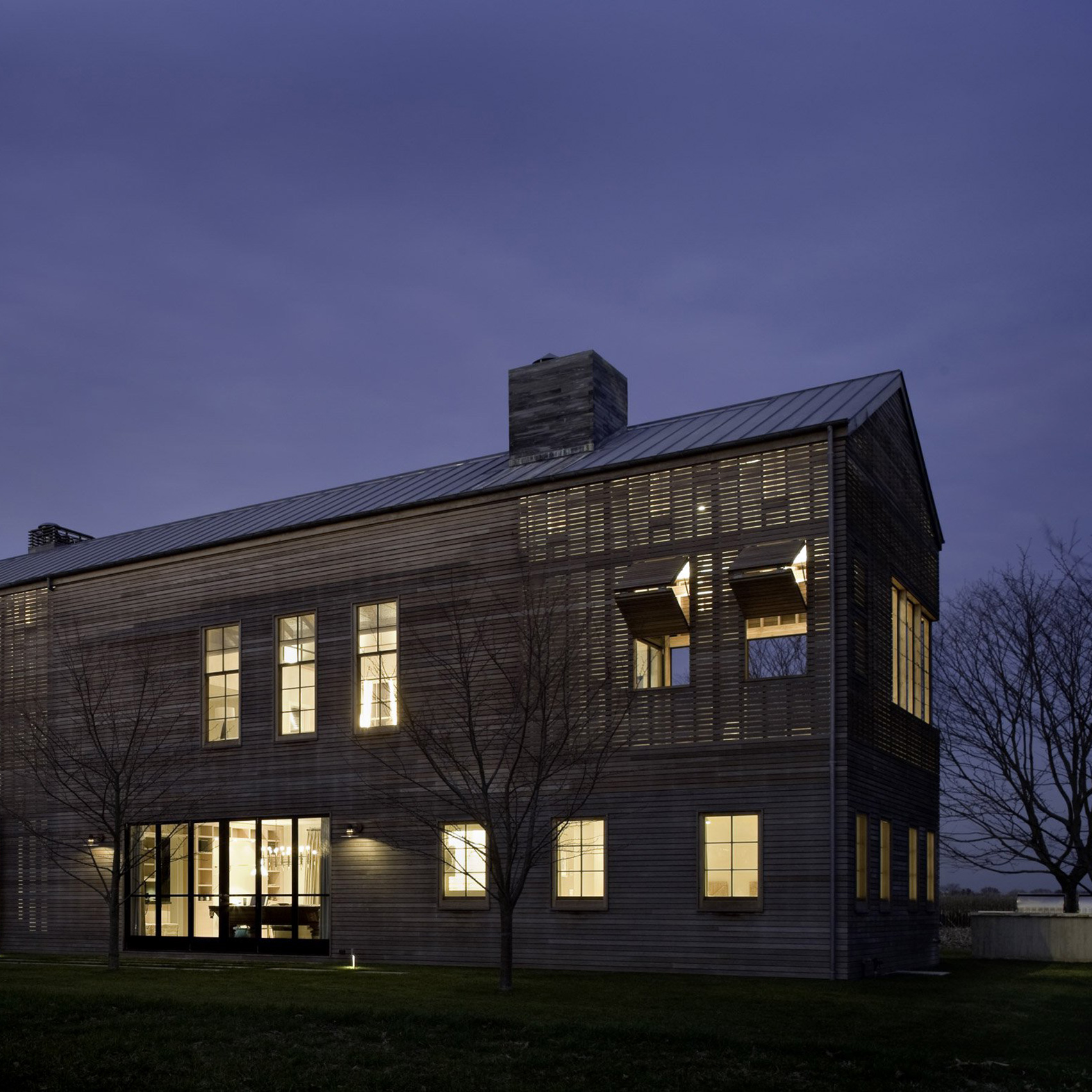 Lights glow through facades of Hamptons home by Leroy Street Studio-0