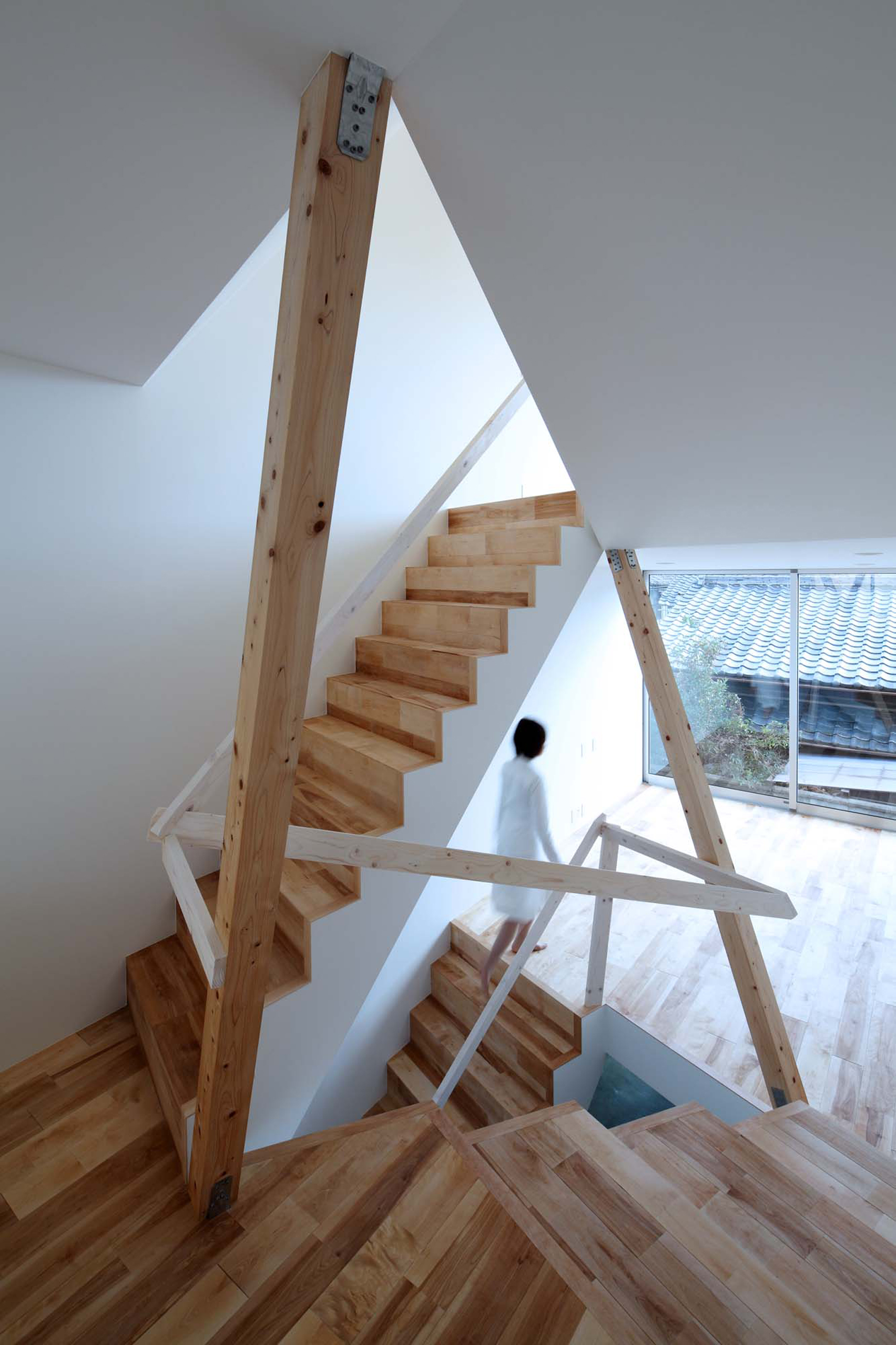 Timber frame projects into rooms and stairwell of compact Kyoto home-2