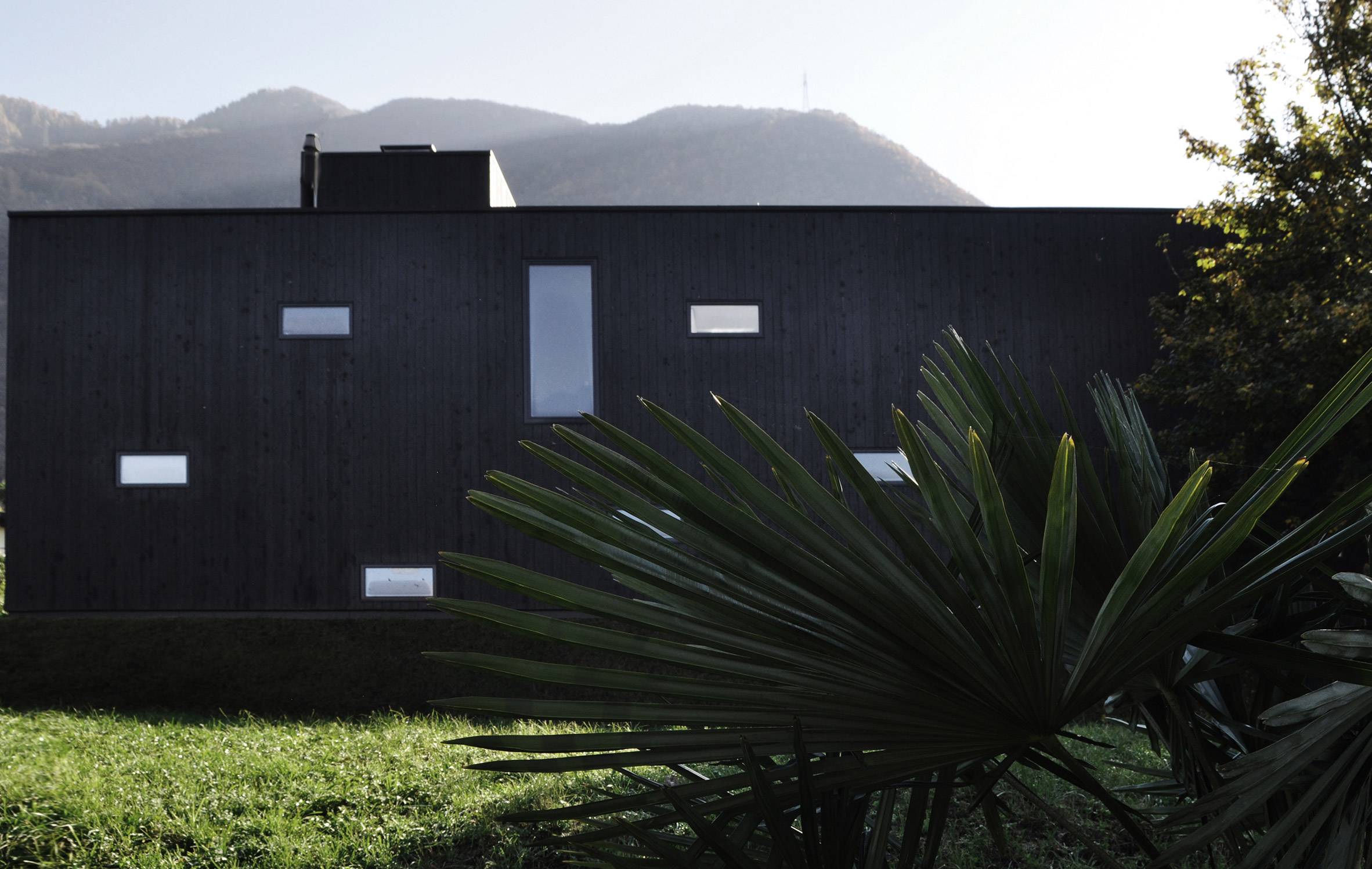 This prefabricated wooden holiday home is clad in charred timber boards-5