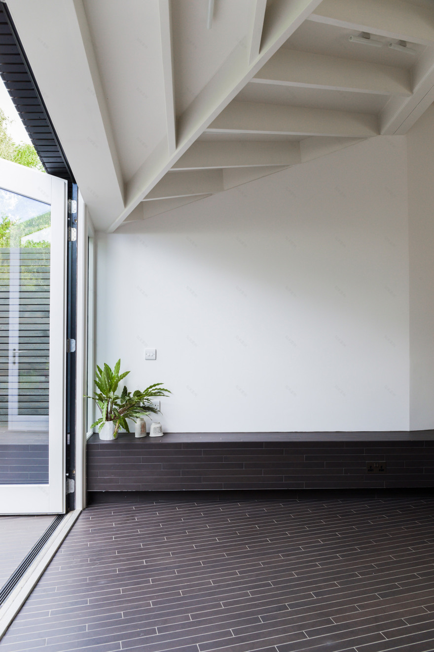 Angular doors connect tapered extension by Mustard Architects with patio-11