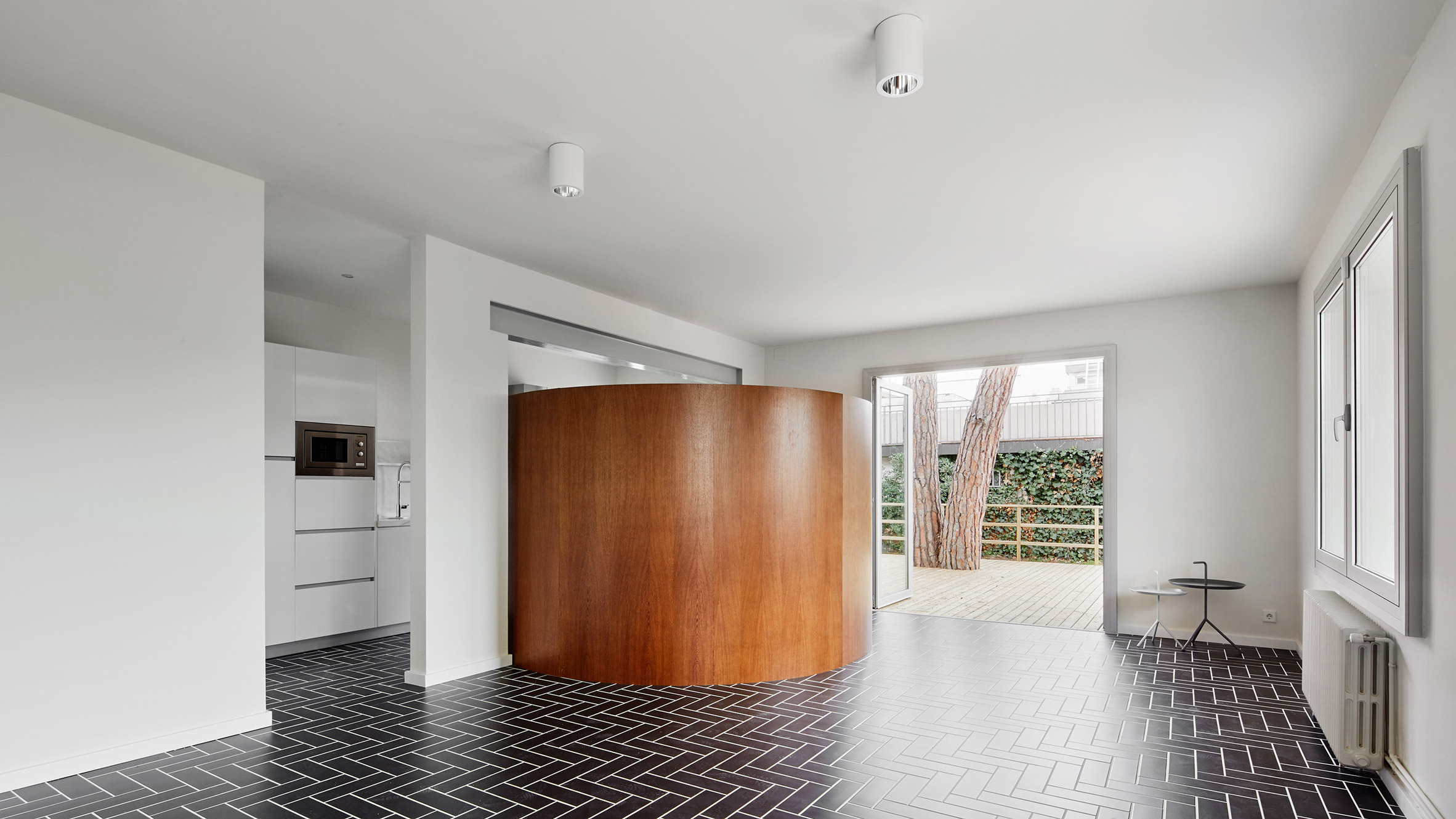 Revamped Barcelona house features herringbone floors and a covert dining area-0