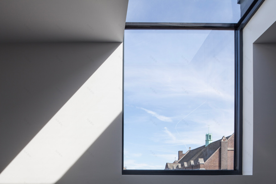 Mulroy Architects extends house with angled skylights and glass passage-16